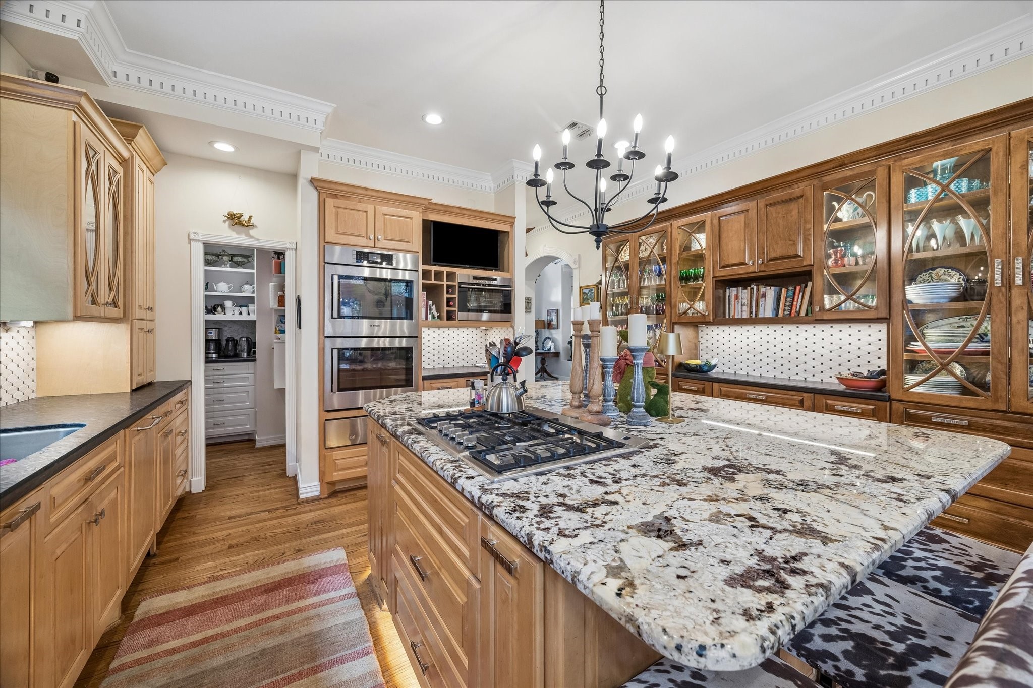 A large walk-in pantry complements the kitchen with space for a coffee or tea bar! Pantry also features lockable china/silver drawers, lazy Susan cabinet, and a broom cabinet.