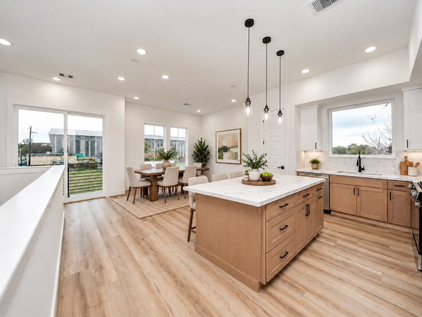 Virtually staged second-floor dining area featuring an open-concept layout, spacious kitchen with oversized island, large windows, and balcony access.