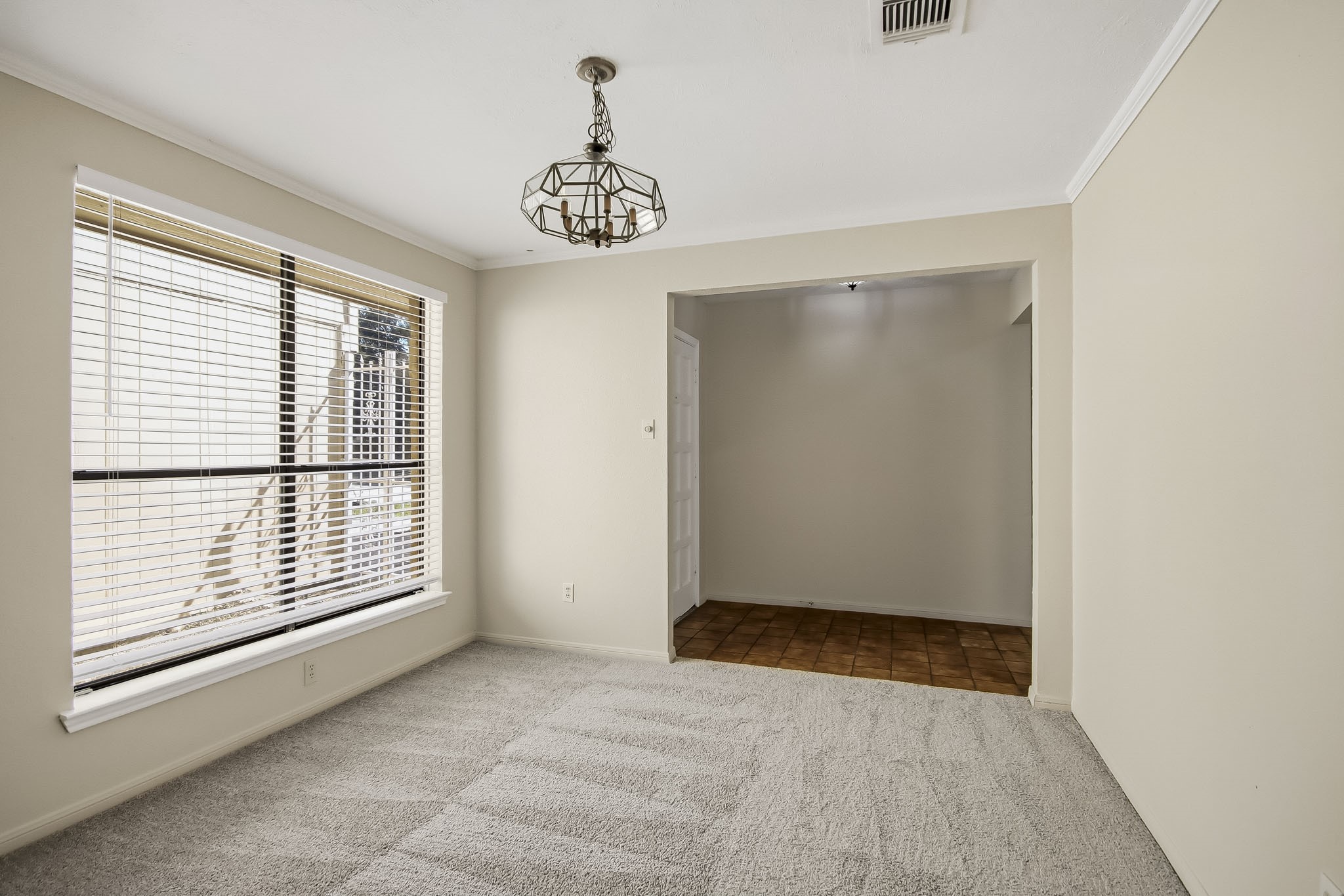Just off the entryway is a versatile space, perfect for a formal dining room, home office, or additional sitting area.