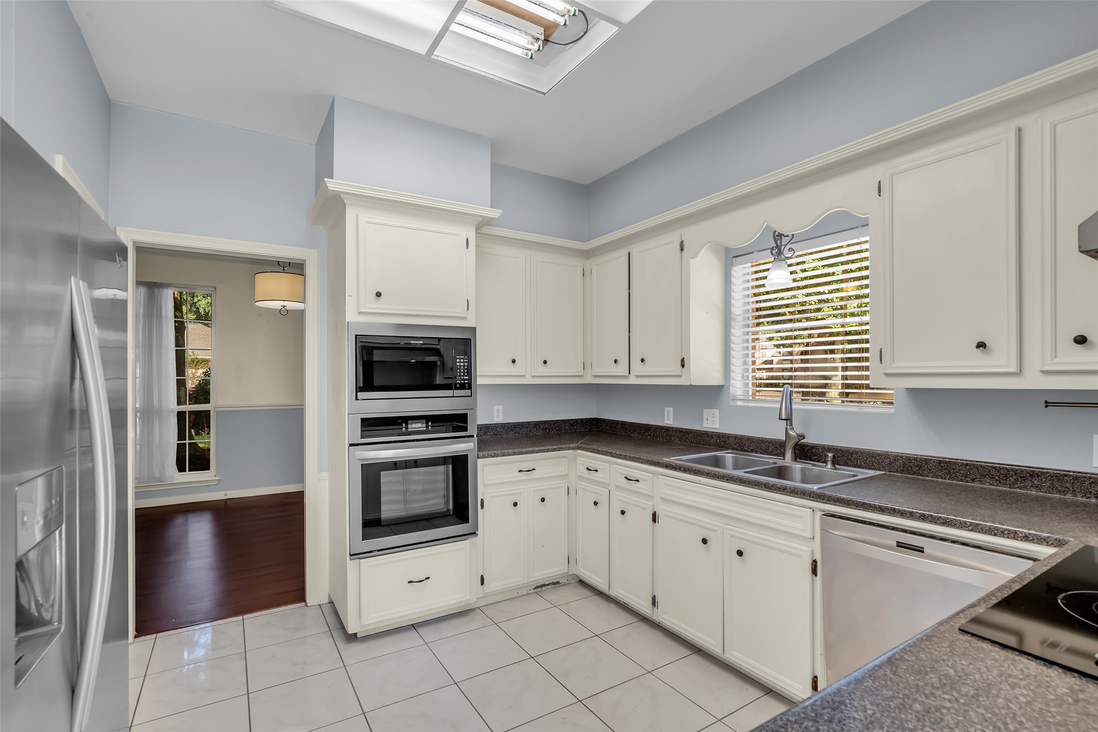 This full view of the kitchen showcases its functional layout and ample cabinet space for storage.