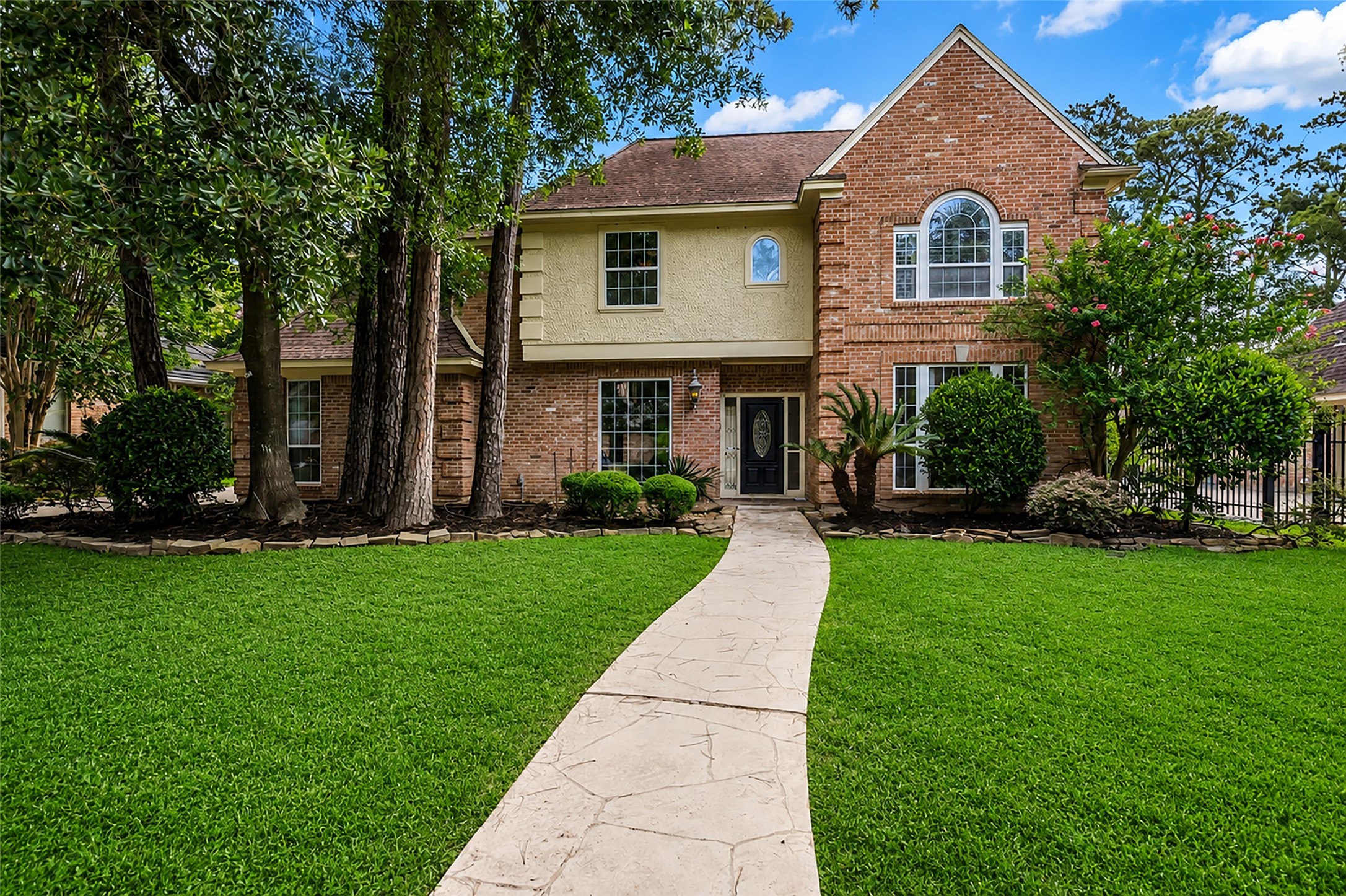This charming home makes a great first impression with its attractive brick and wood exterior, inviting curb appeal, and timeless character.