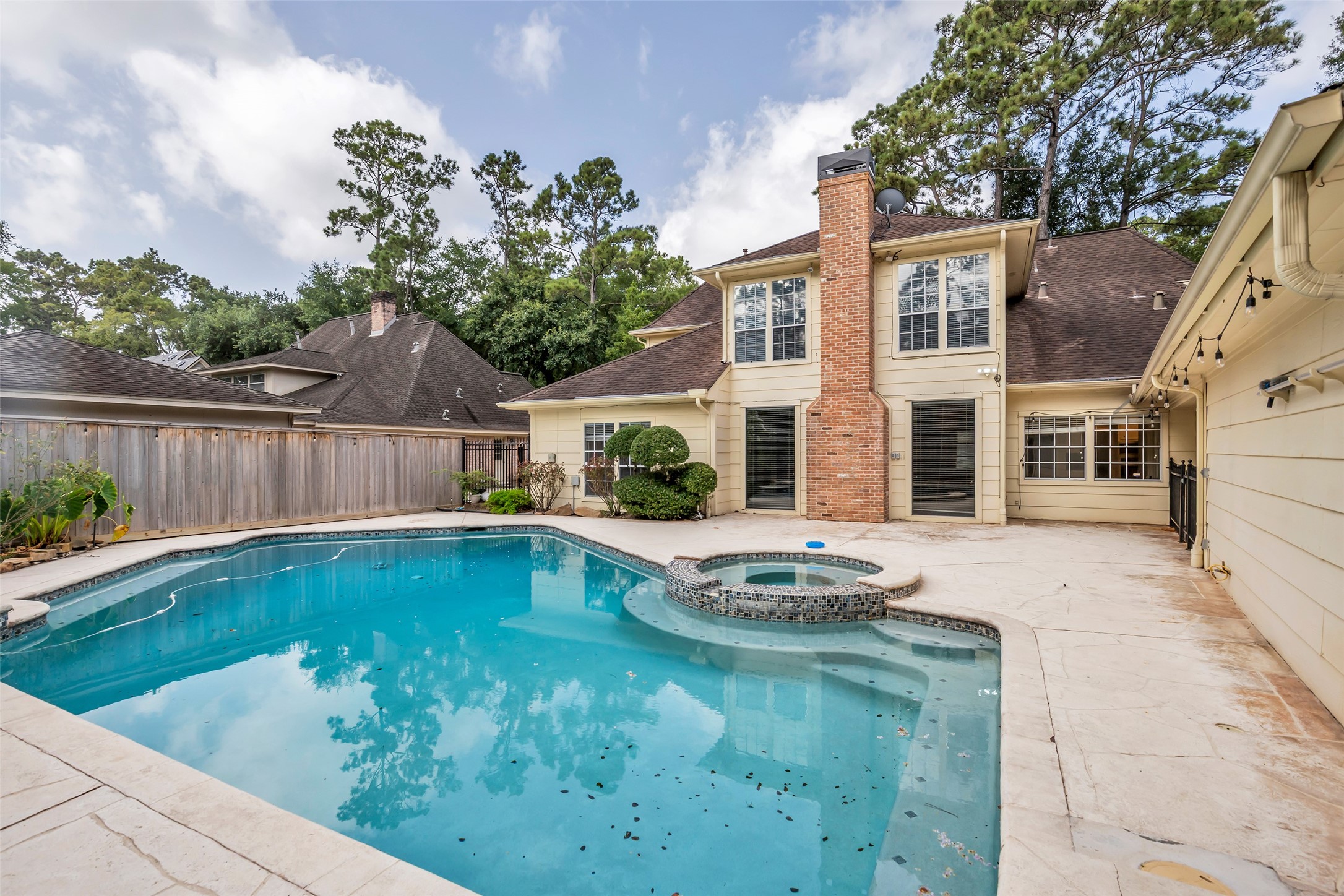 View of the rear of the home with a fully fenced backyard, providing privacy and a defined outdoor space.