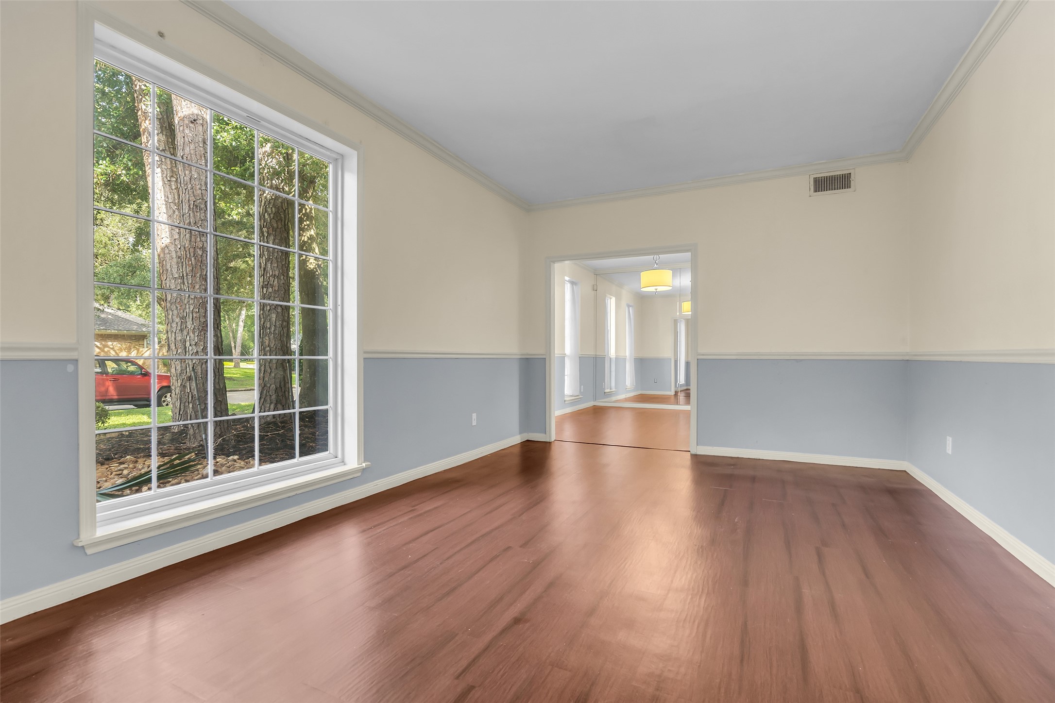 The living room faces the front lawn, and its large window fills the space with natural light.