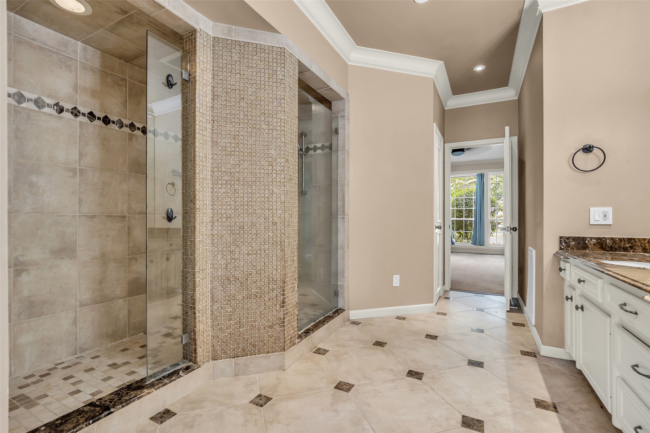 The primary bathroom features a spacious, spa-inspired layout