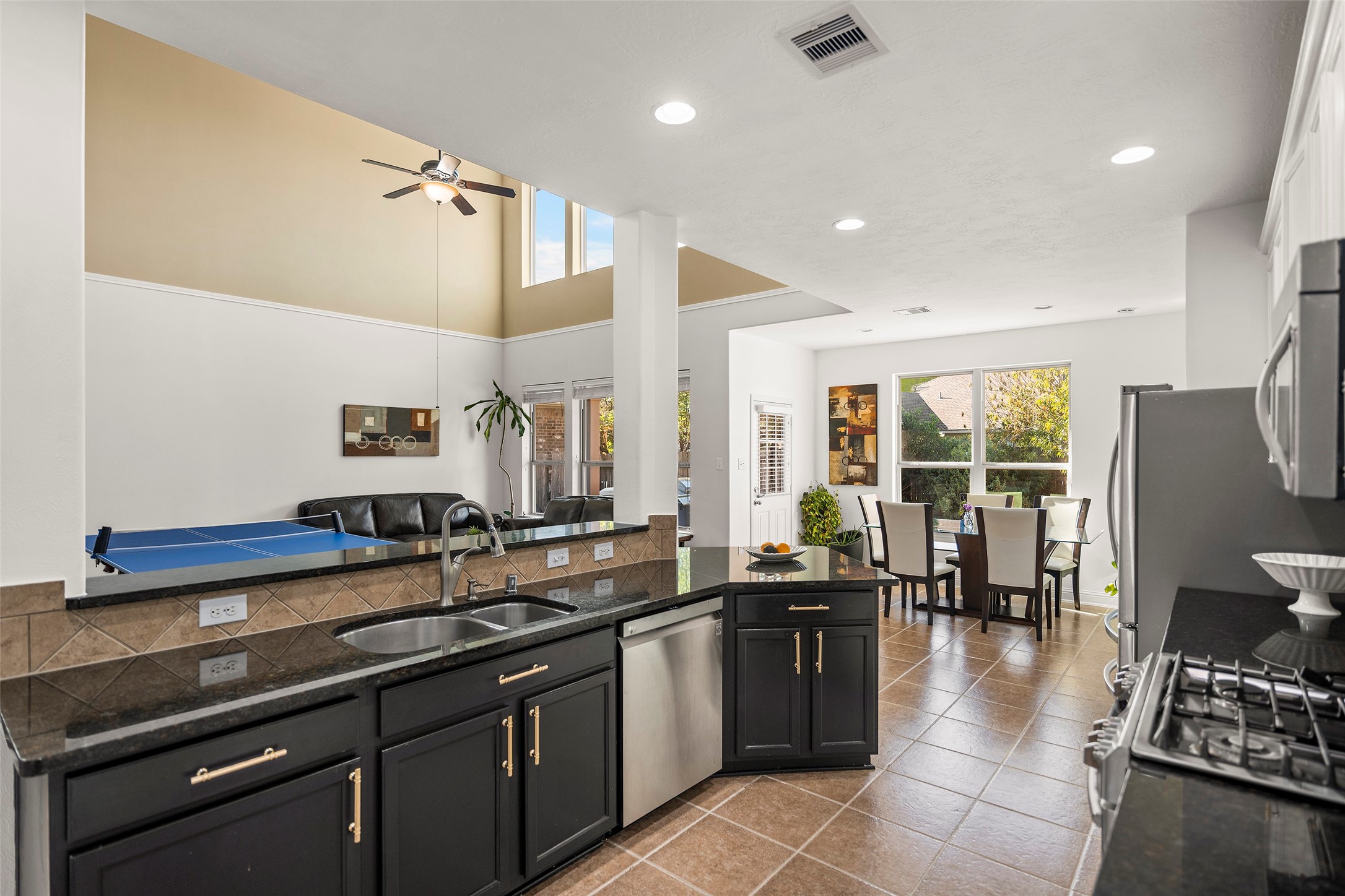 Featuring stainless steel appliances and a beautiful breakfast bar, this kitchen opens into the living room, creating the perfect space to connect with family while cooking.