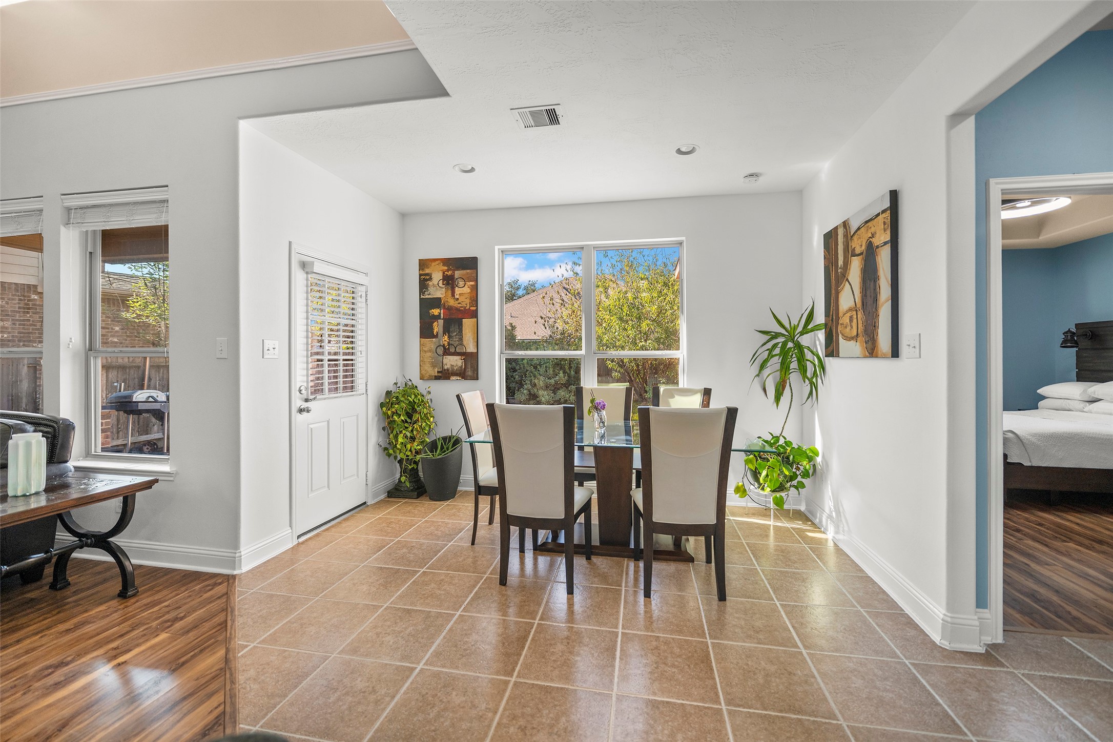 Spacious breakfast room featuring an abundance of natural light and ample space for a six-person dining table.