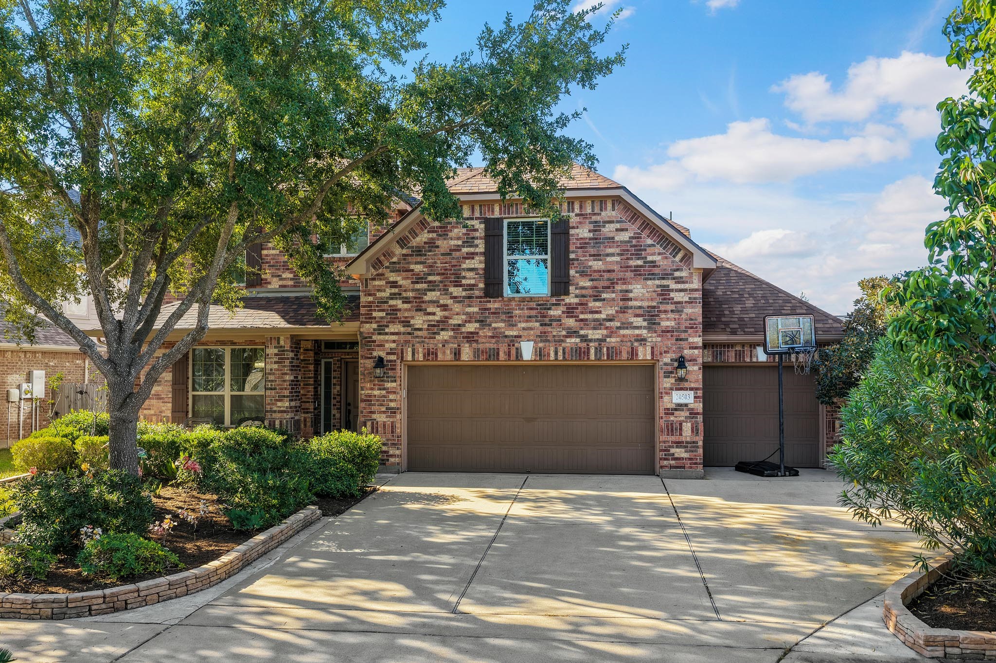 Spacious 3-car garage featuring durable epoxy flooring, a convenient utility sink, and direct access to the backyard.