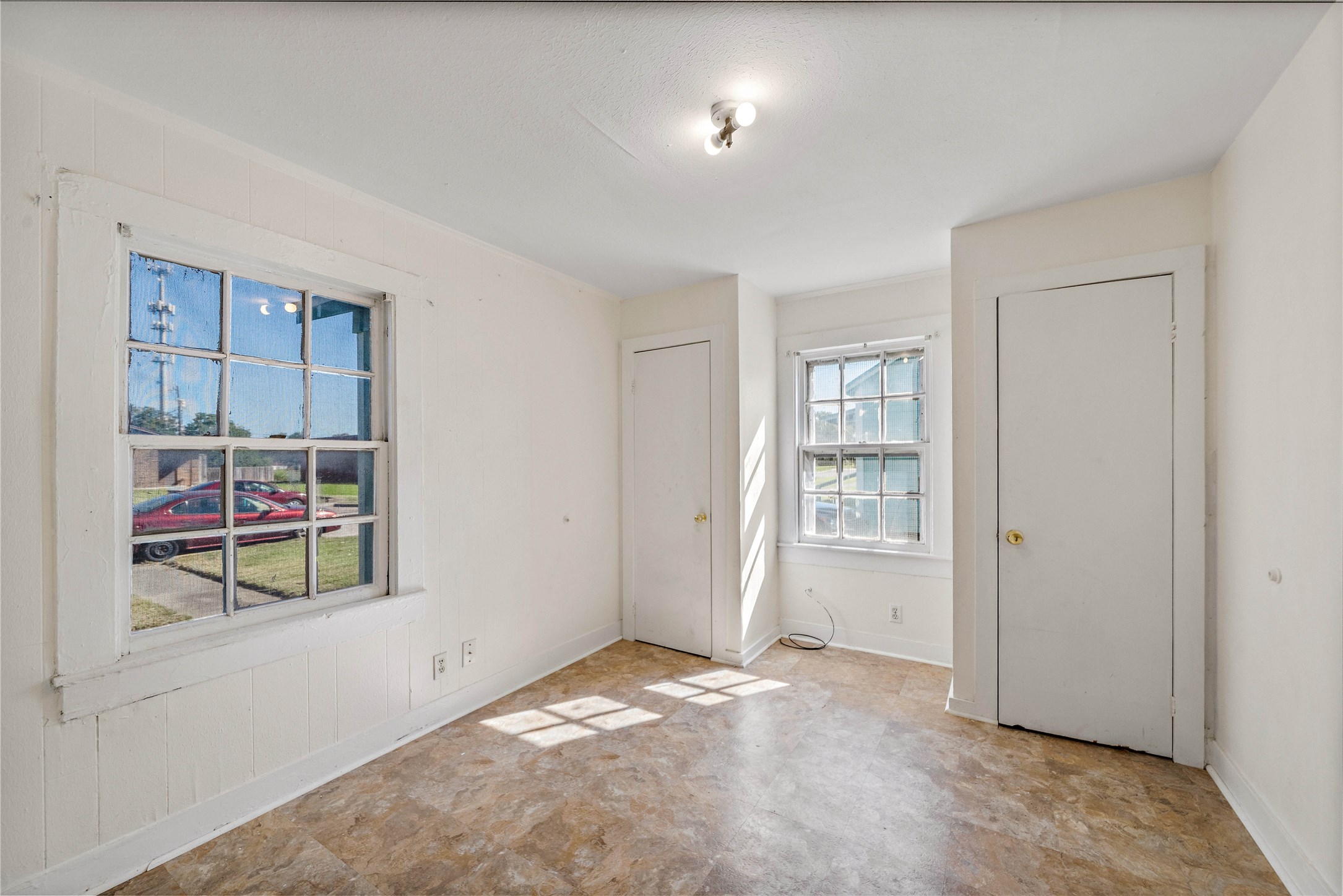 Large bedroom with an area for a bench or desk. Large bedroom with an area for a bench or desk.