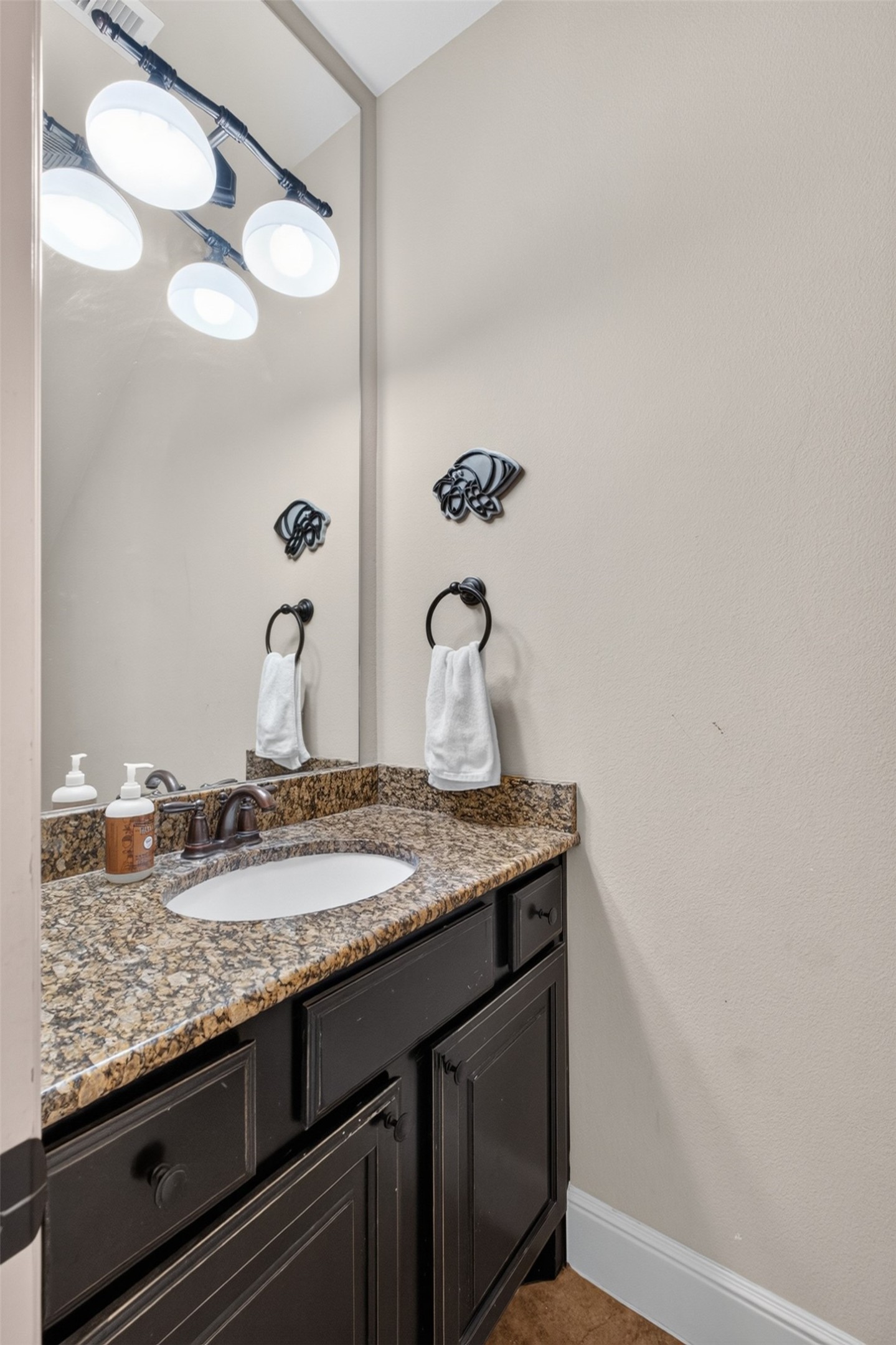 Elegant and convenient half bath downstairs with built in cabinets