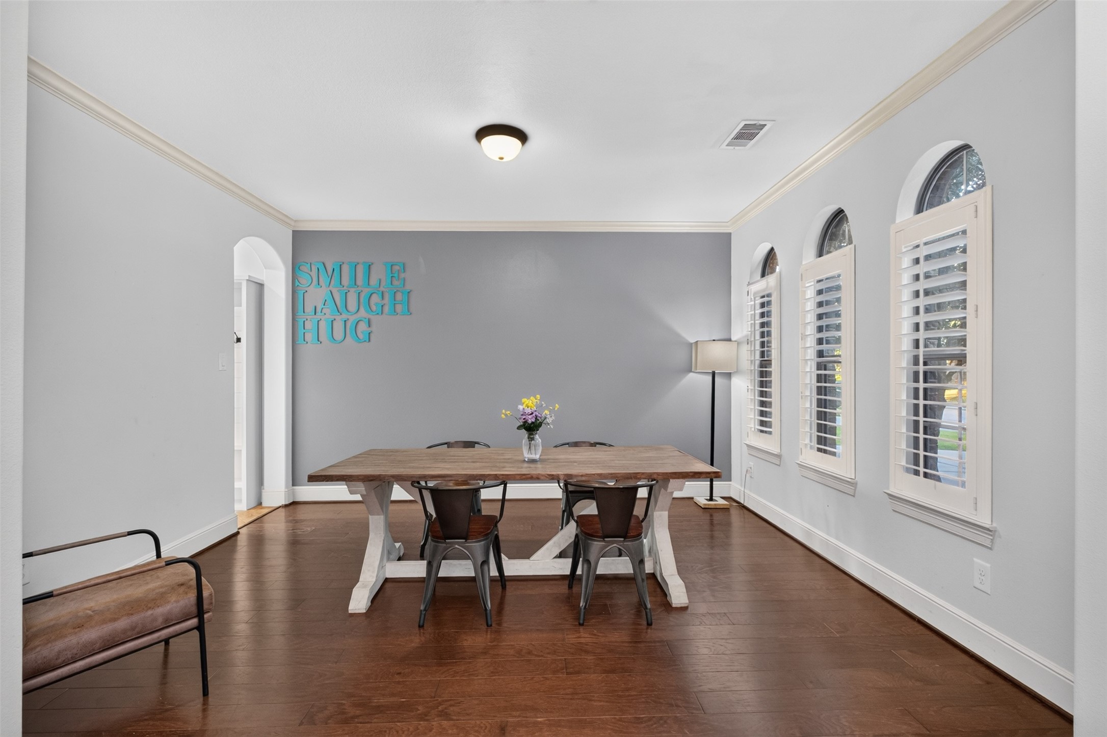 The dining room leads through to the kitchen and boast wood floors, crown molding and plantation shutters