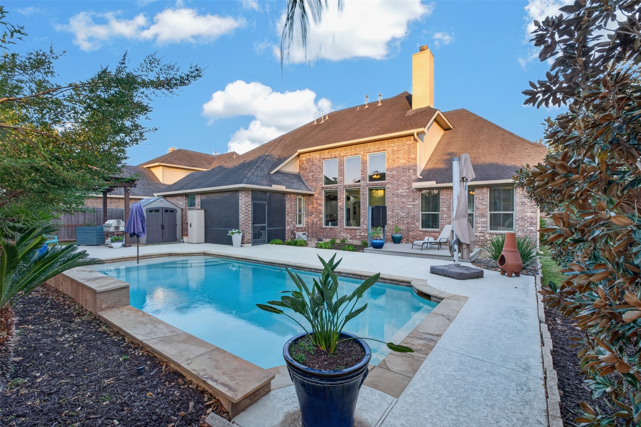 View of the beautiful backyard with separate entertaining spaces from the covered back porch, gazebo to the left and raised deck View of the beautiful backyard with separate entertaining spaces from the covered back porch, gazebo to the left and raised deck