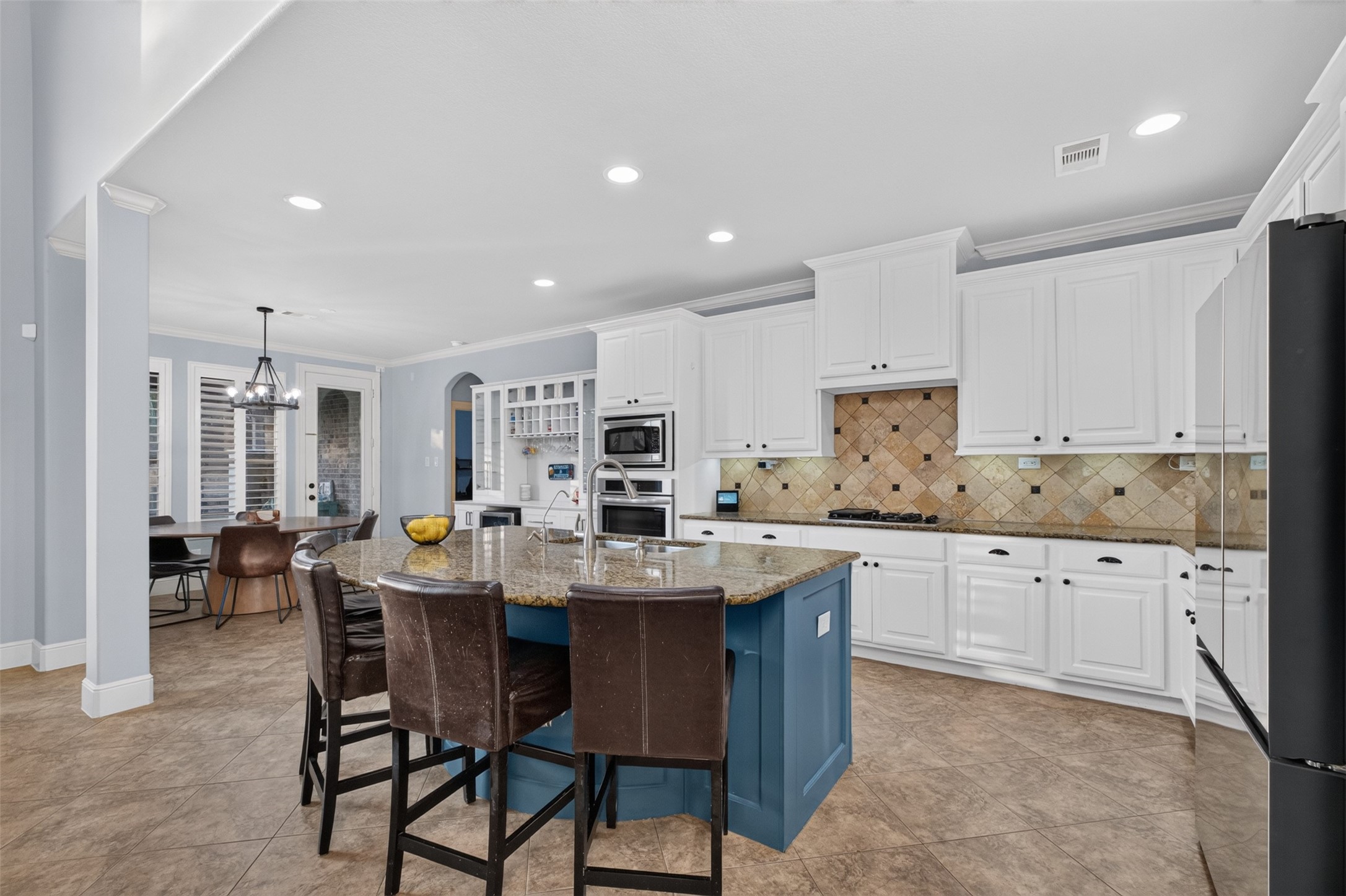 The kitchen has a large island and leads to the breakfast area