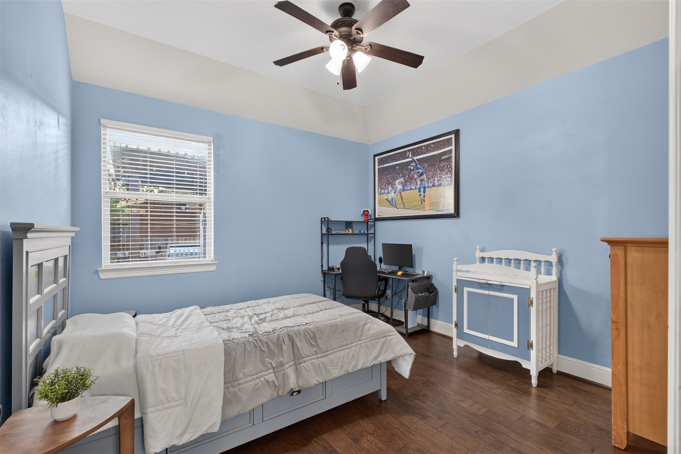 Guest bedroom on the first floor with hardwood floors and walk in closet