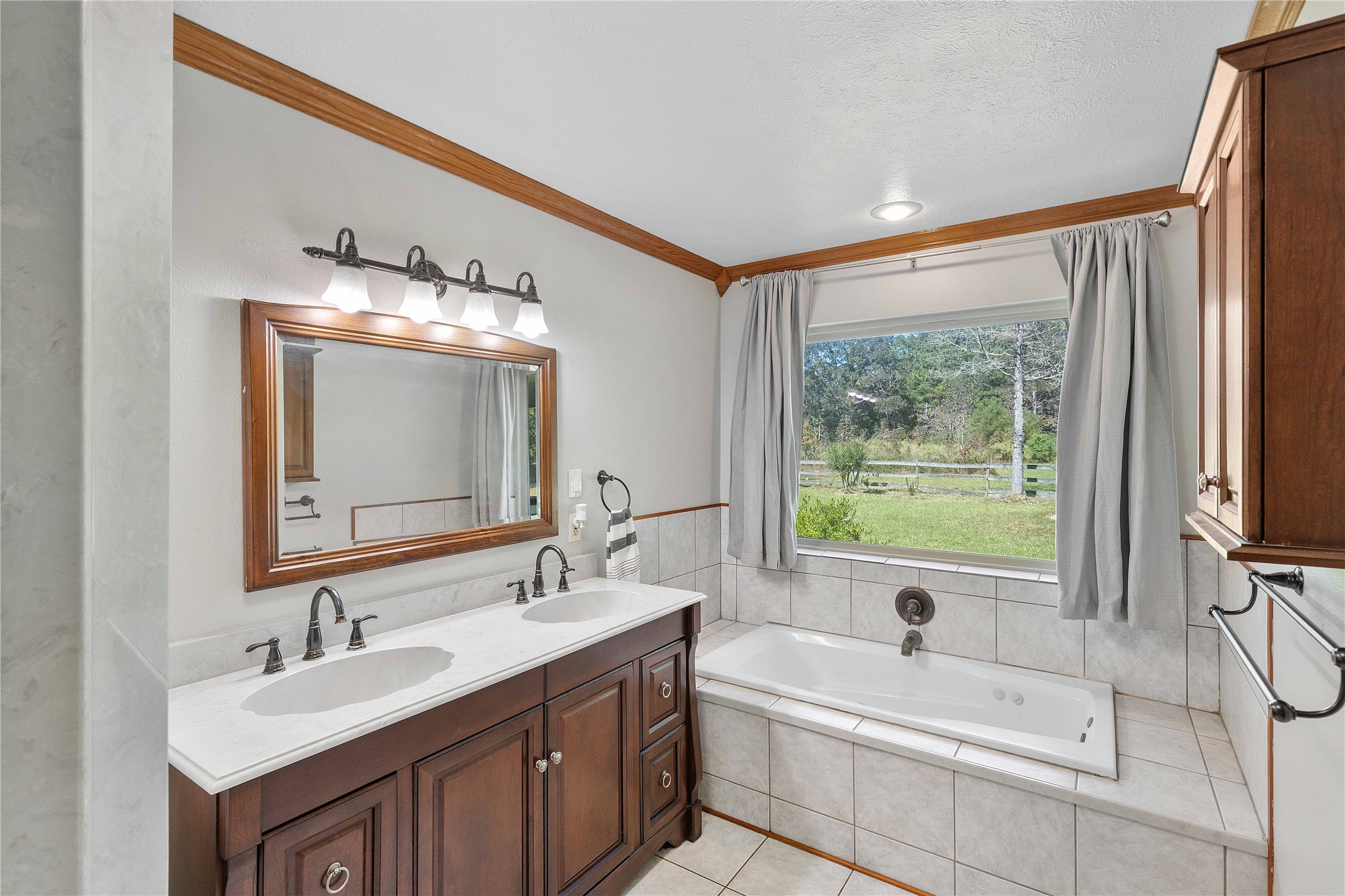 Primary bathroom with separate tub and shower and double sinks