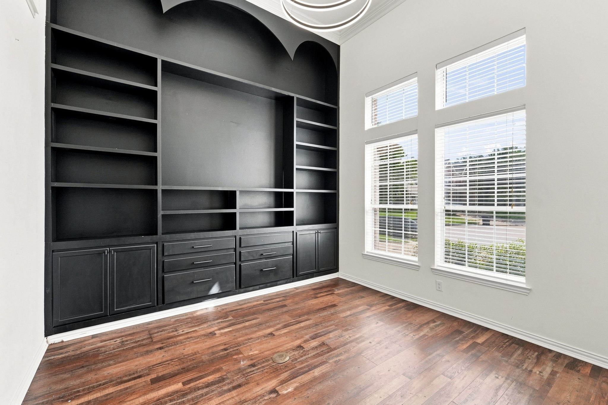 Home office with built-in shelves and cabinets