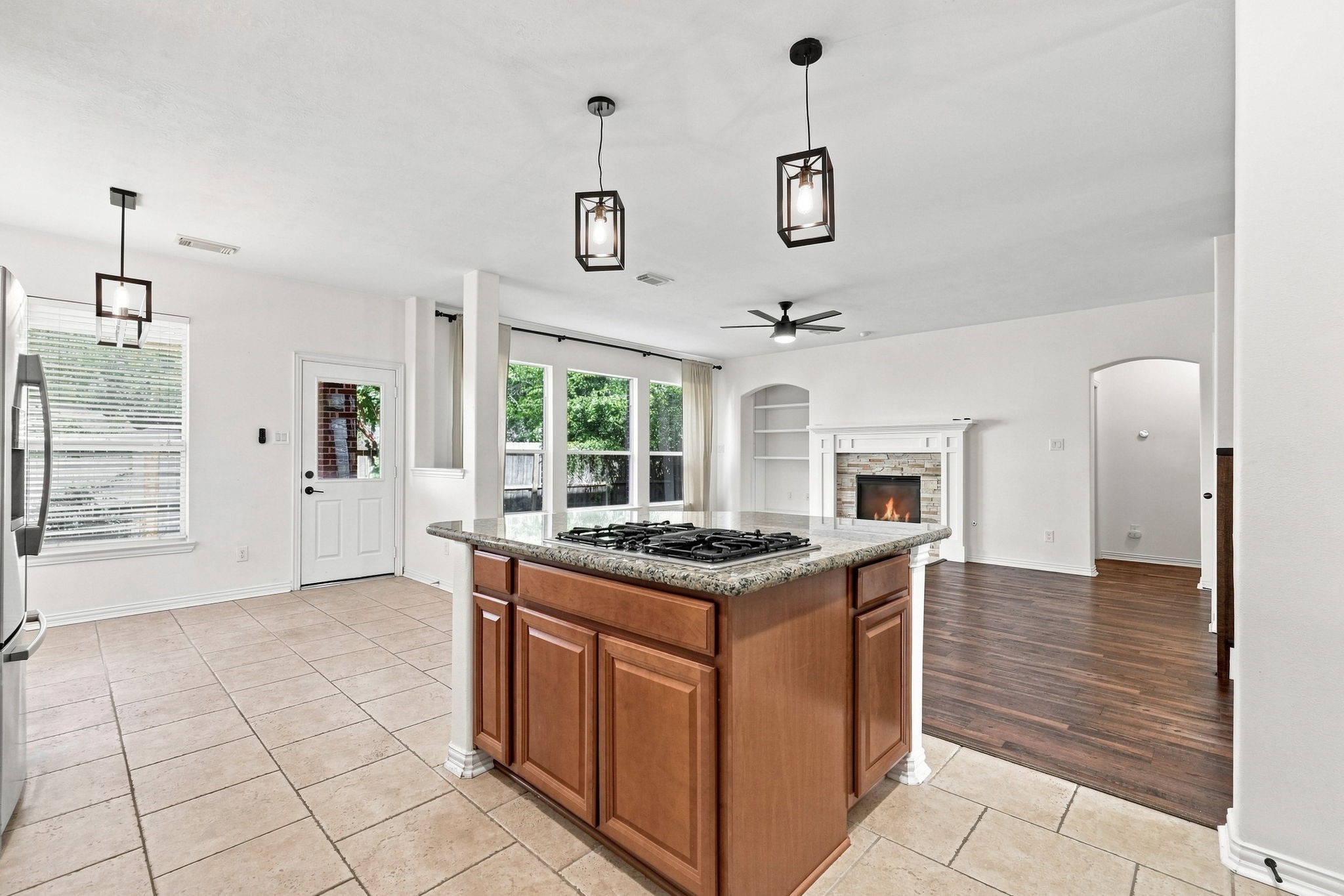 Viewpoint from kitchen showing breakfast area, door to backyard, family room