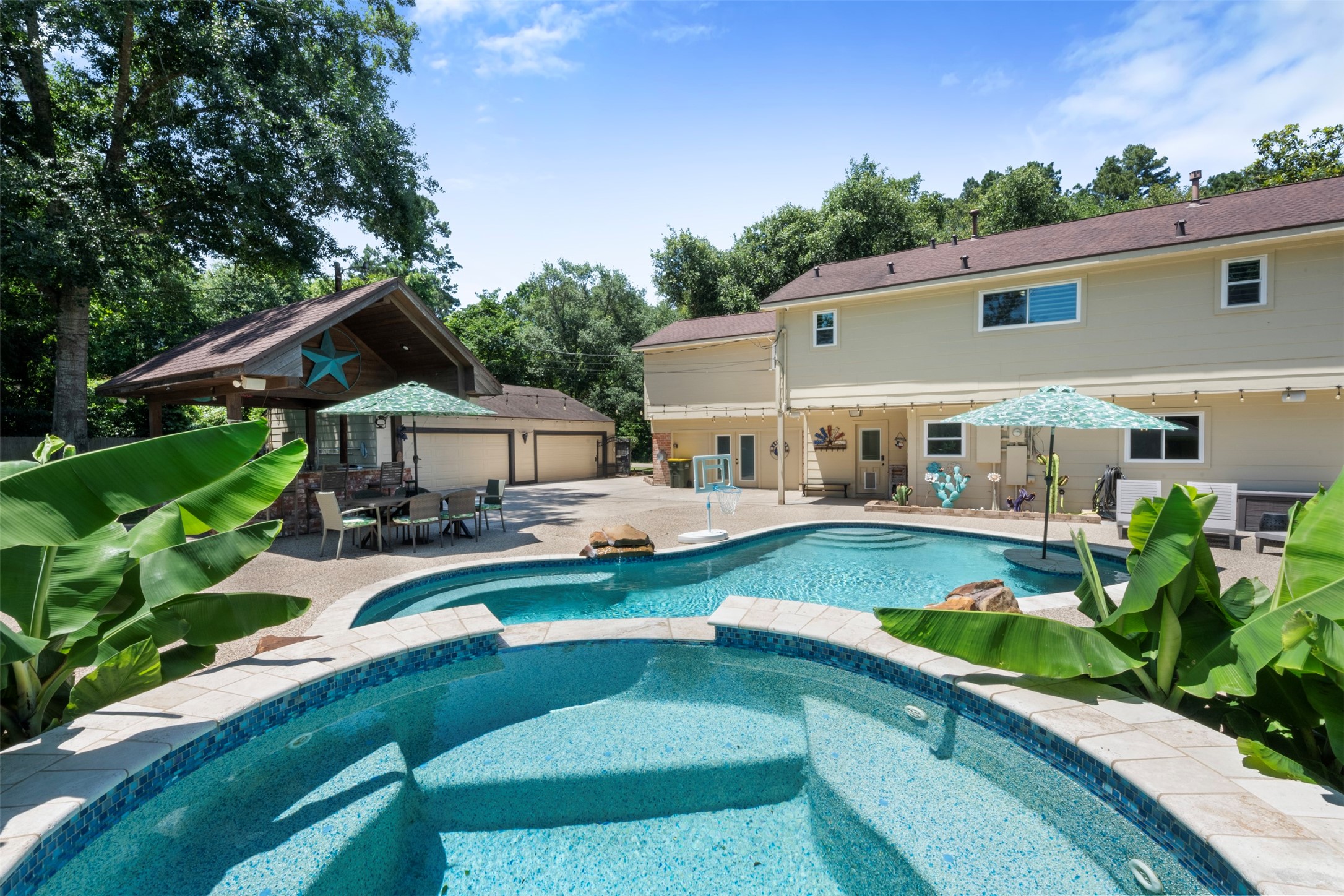 Pool and jacuzzi. Detached garage -- converted man-cave in back