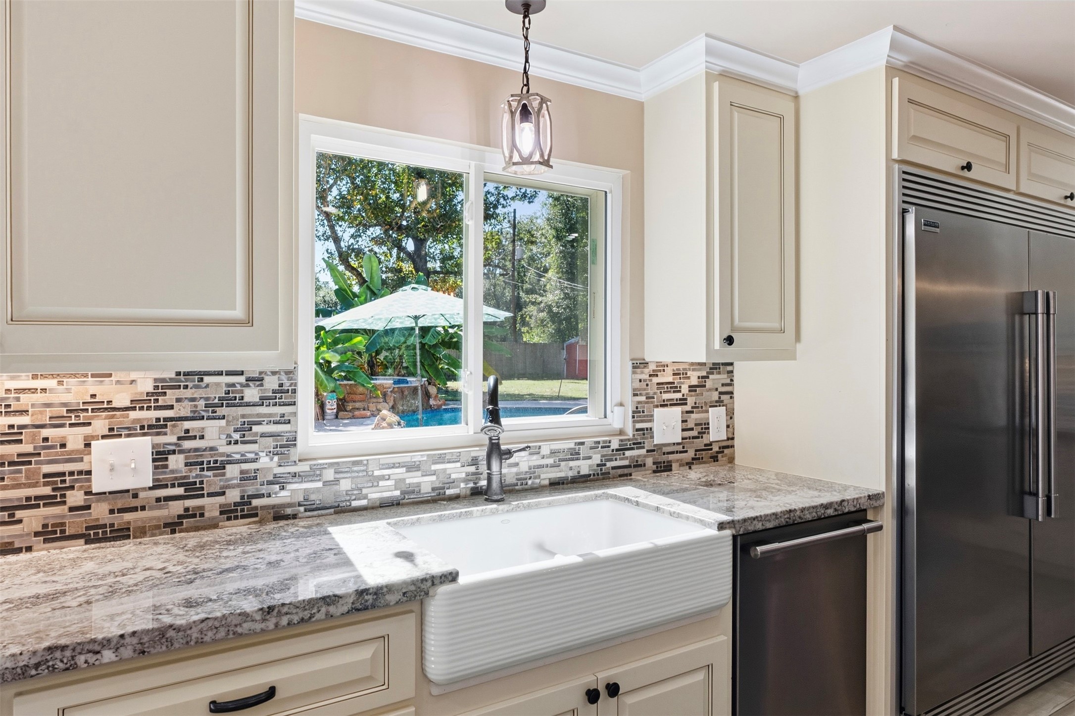 Farmhouse sink with window overlooking the pool