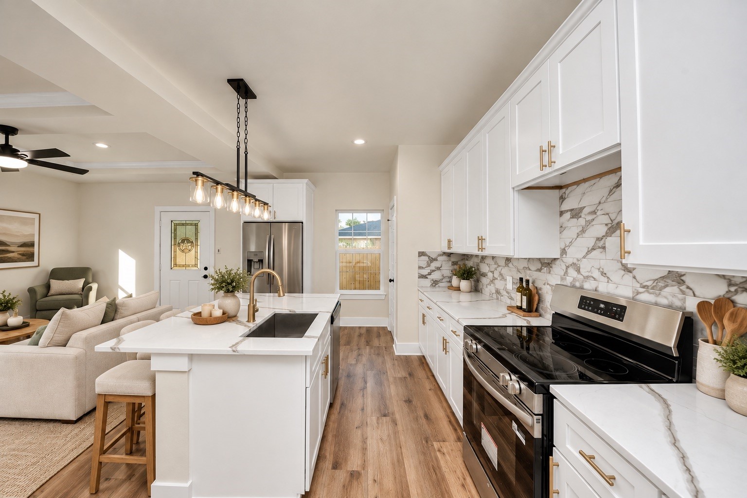 Spacious kitchen featuring a large center island with undermount sink, modern fixtures, soft-close cabinets & drawers, and an open layout overlooking the main living area | Virtually staged