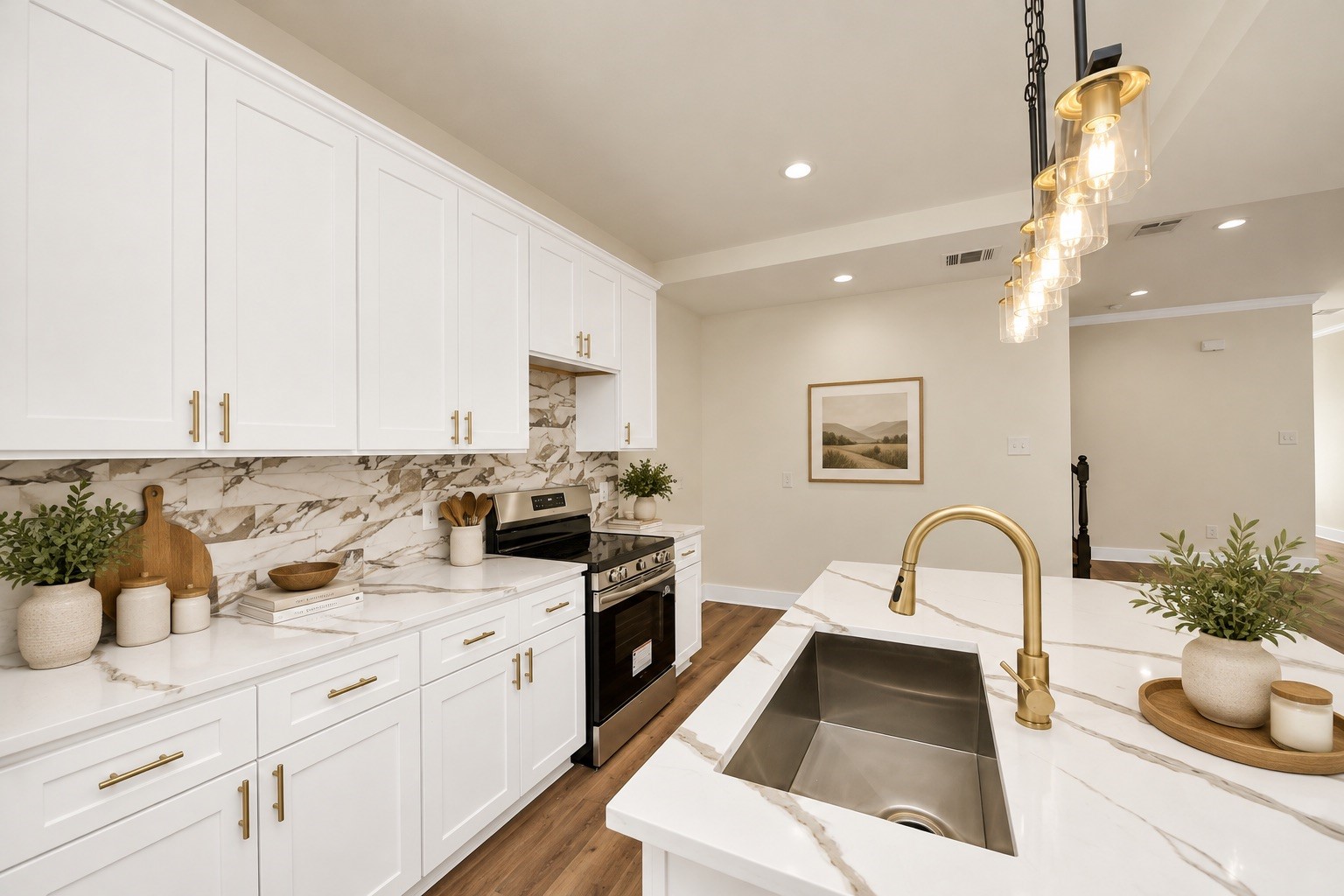 Detailed view showcasing white cabinetry with sleek modern hardware pulls, decorative tile backsplash, quartz countertops, stainless steel appliances & ample cabinet storage.