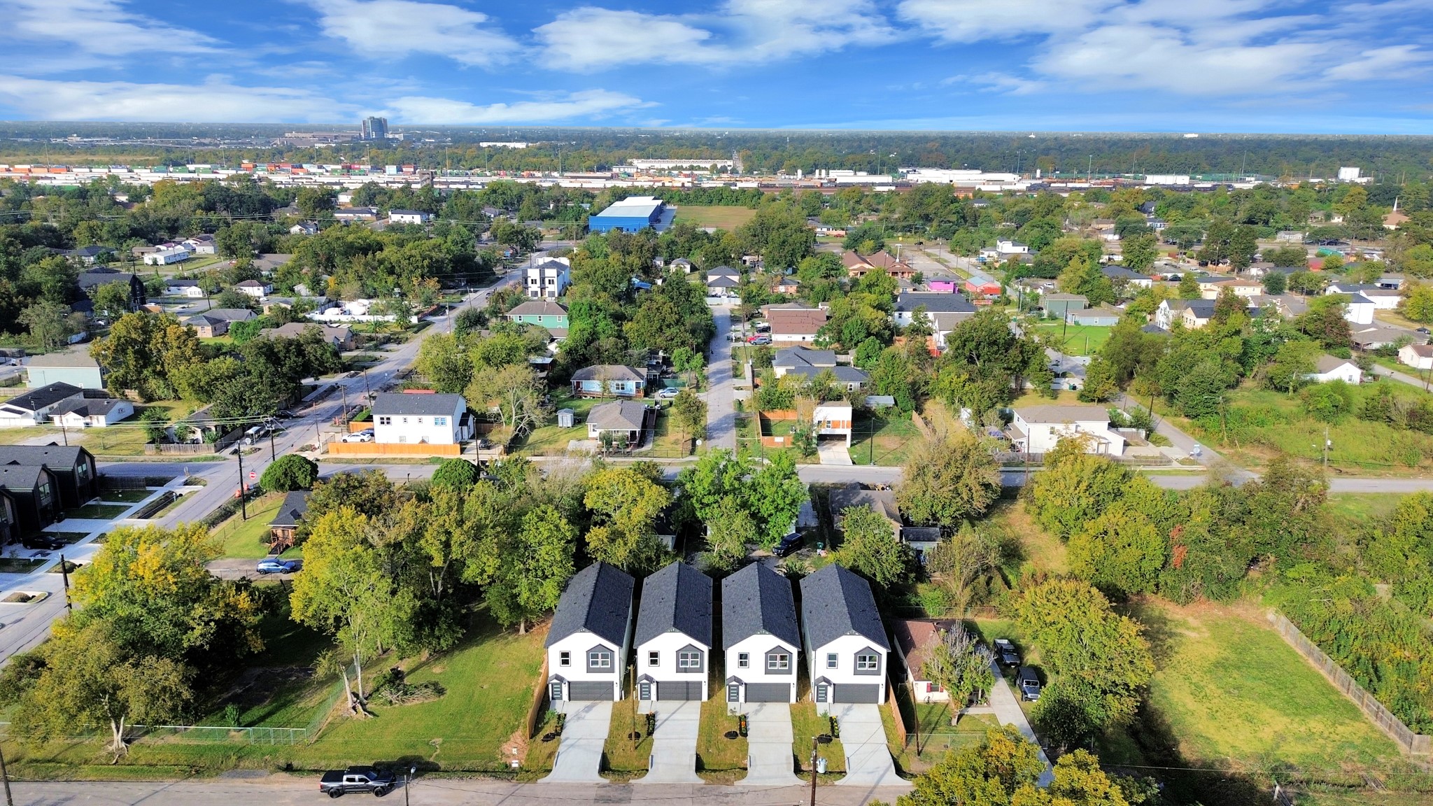 Wide aerial perspective showcasing the four new construction homes along Nielan Street & their location within the established Northeast Houston neighborhood.