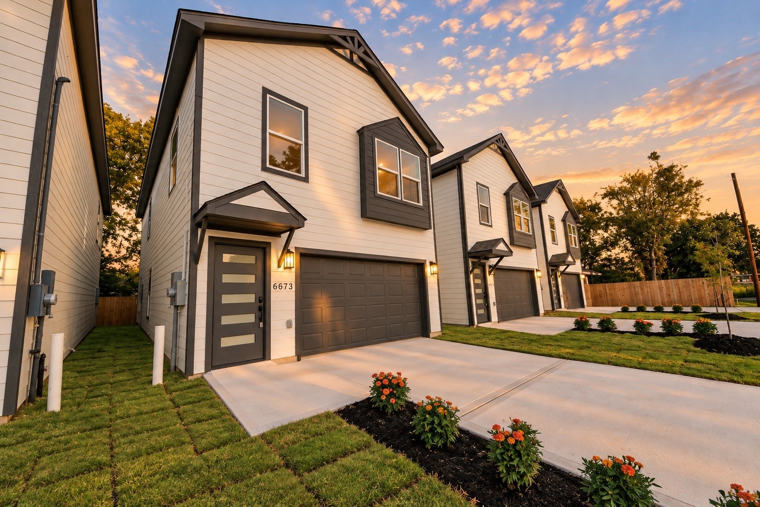 Beautiful front elevation showcasing the home's modern design, decorative exterior accents, covered entry, contemporary front door & spacious 2-car garage.
