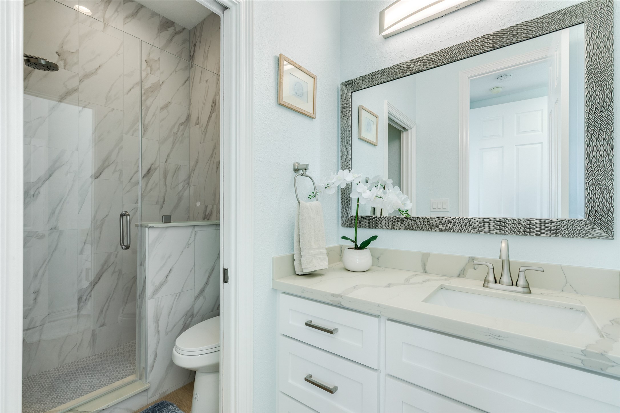 Remodeled full bathroom on the main level has a walk-in shower