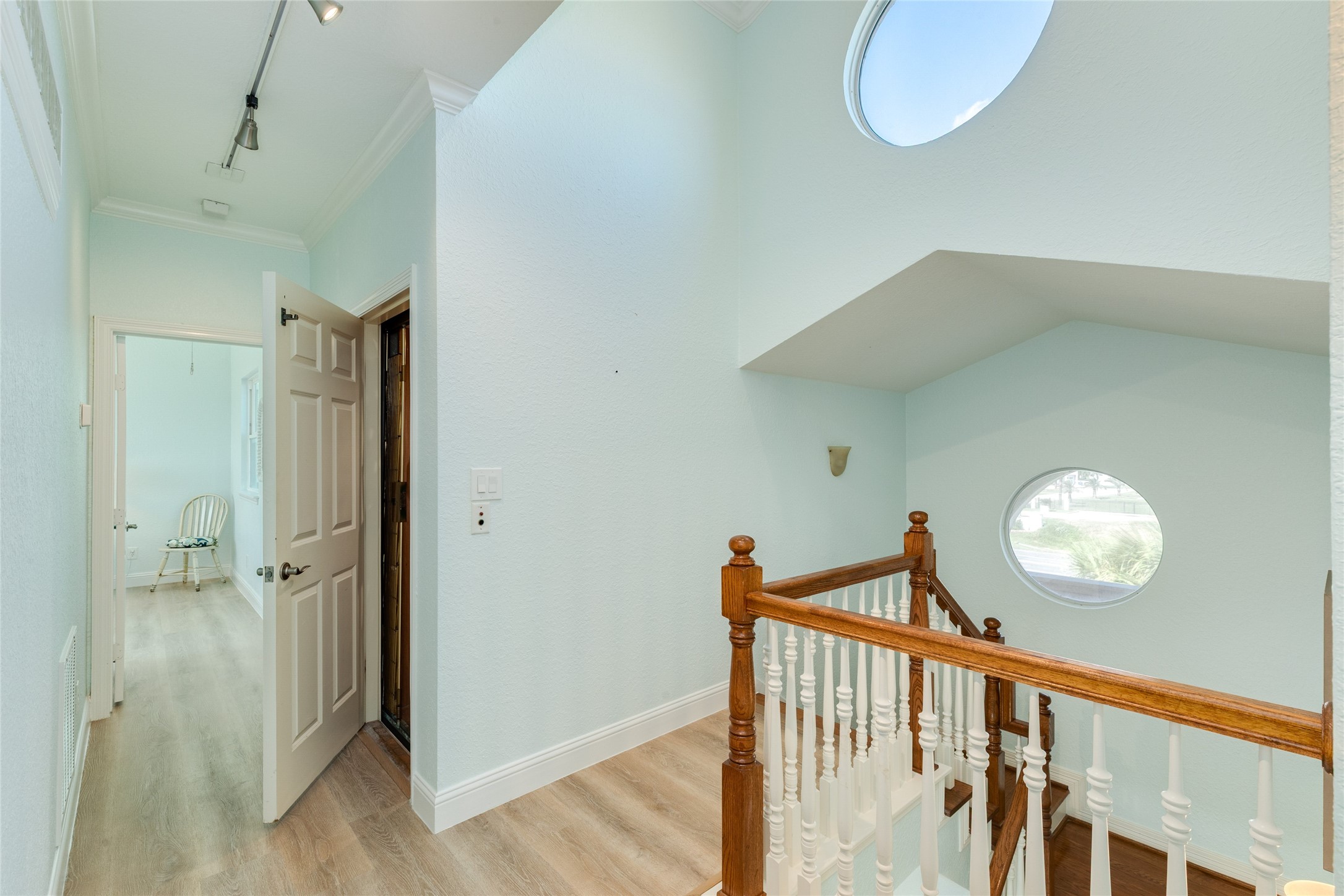 Upstairs landing with decorative porthole windows for lots of natural light