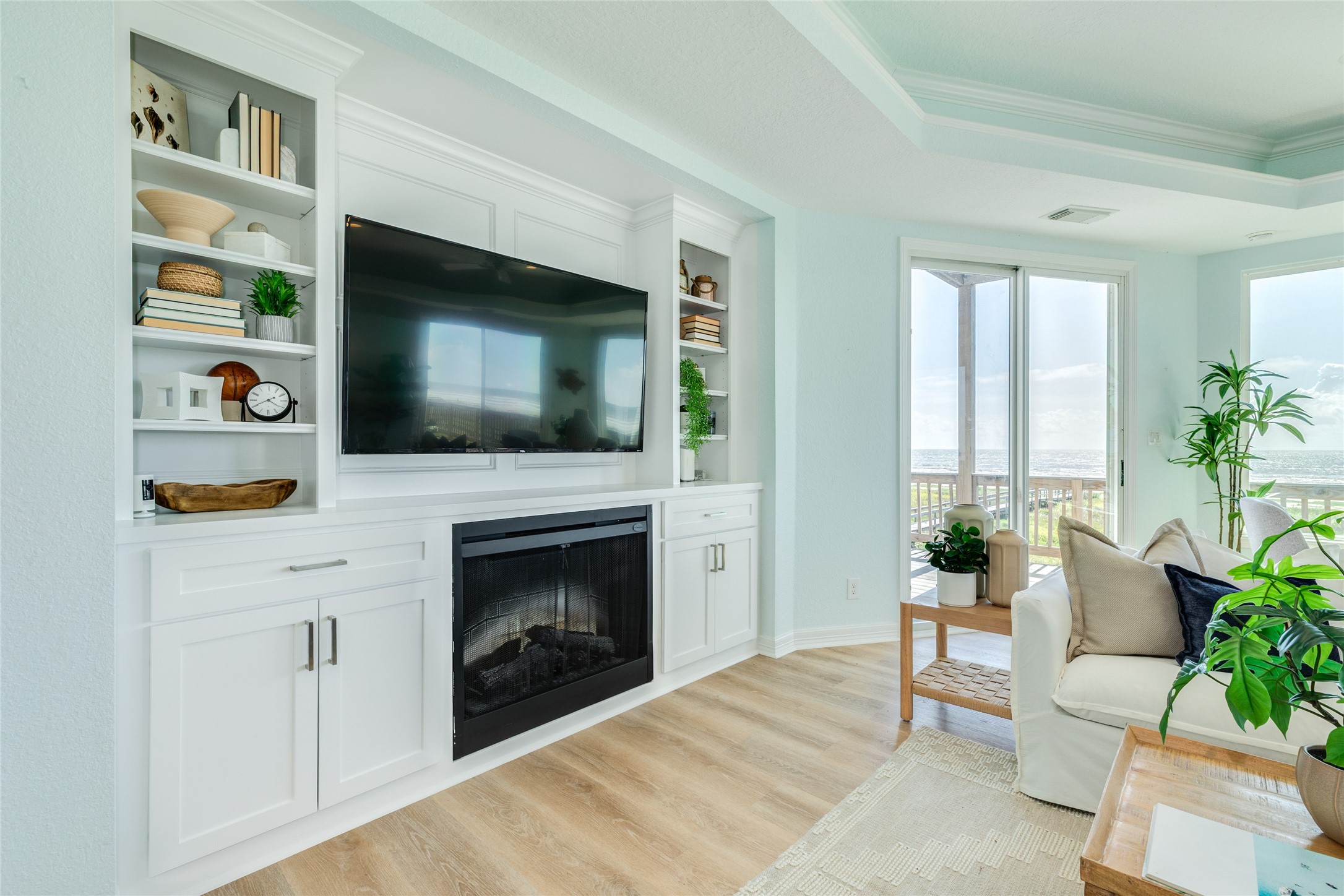 Living Room features an electric fireplace and built-in bookshelves with cabinets
