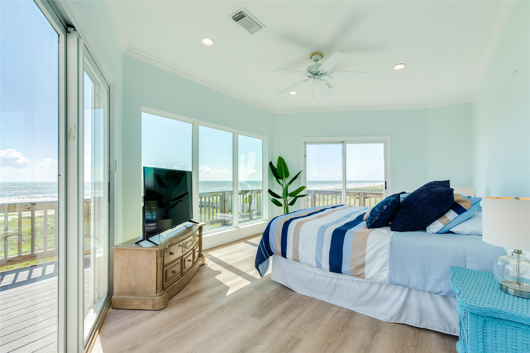 Primary Bedroom upstairs has a wall of windows for 180 degree views of the Beach