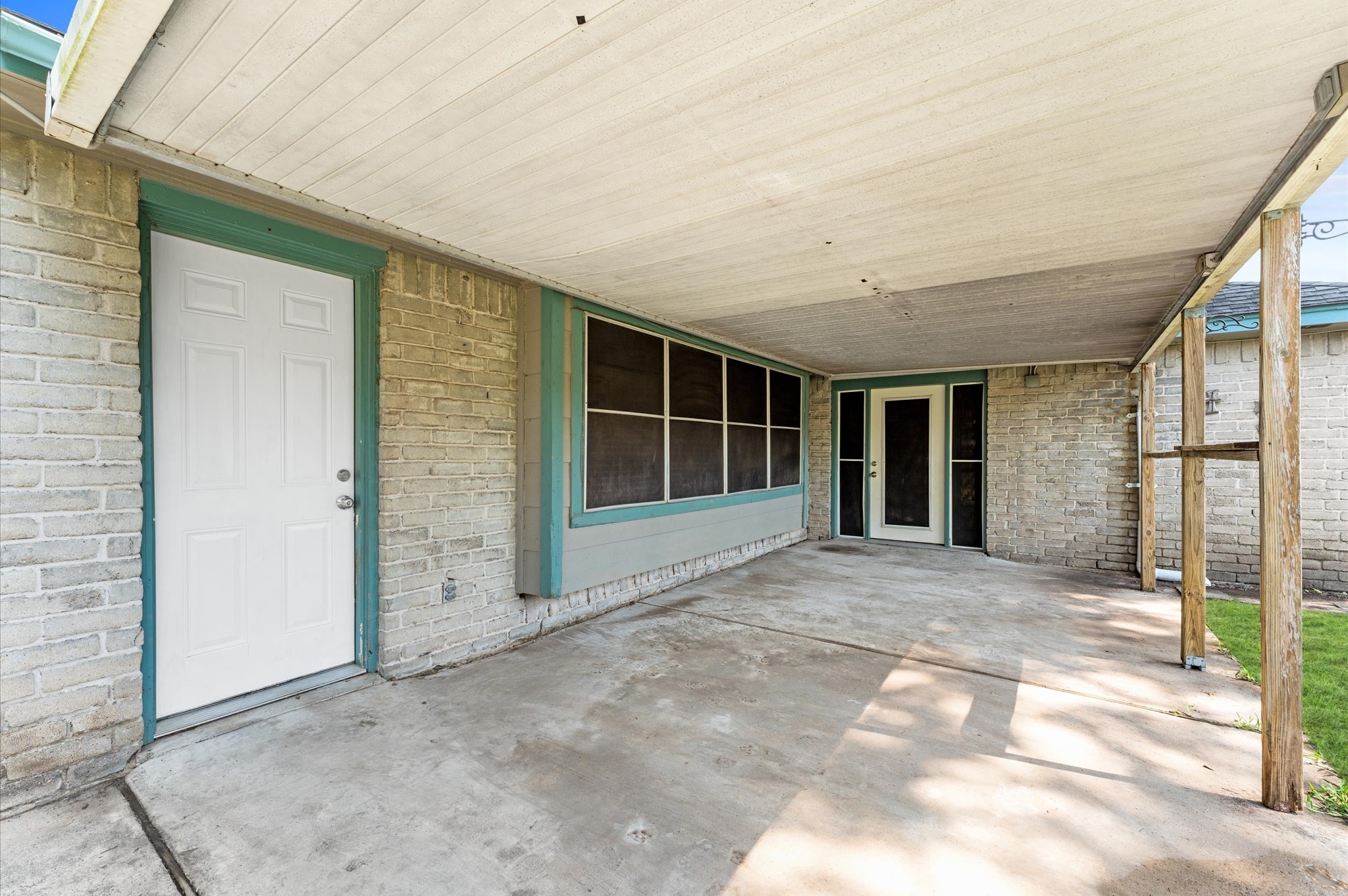 The door on the left opens to the living room, while the door at the far end is a private patio entrance from the primary suite.
