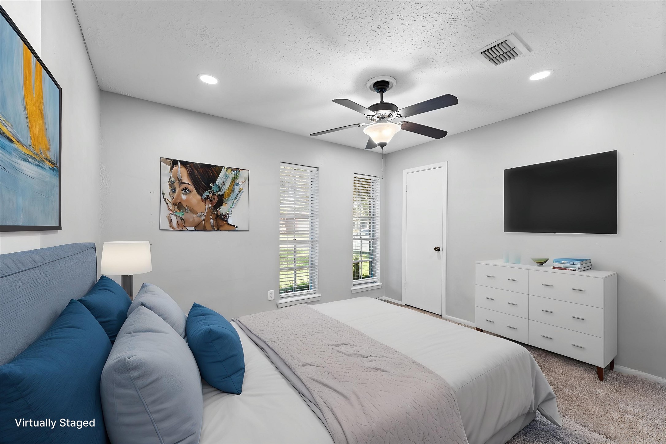 Bedroom 1 offers recessed lighting, plush carpet and a walk-in closet.