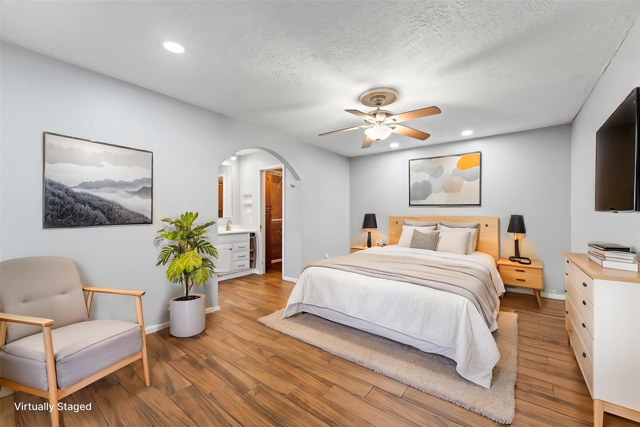 The primary suite features tile plank flooring, recessed lighting, and walk-in closet.