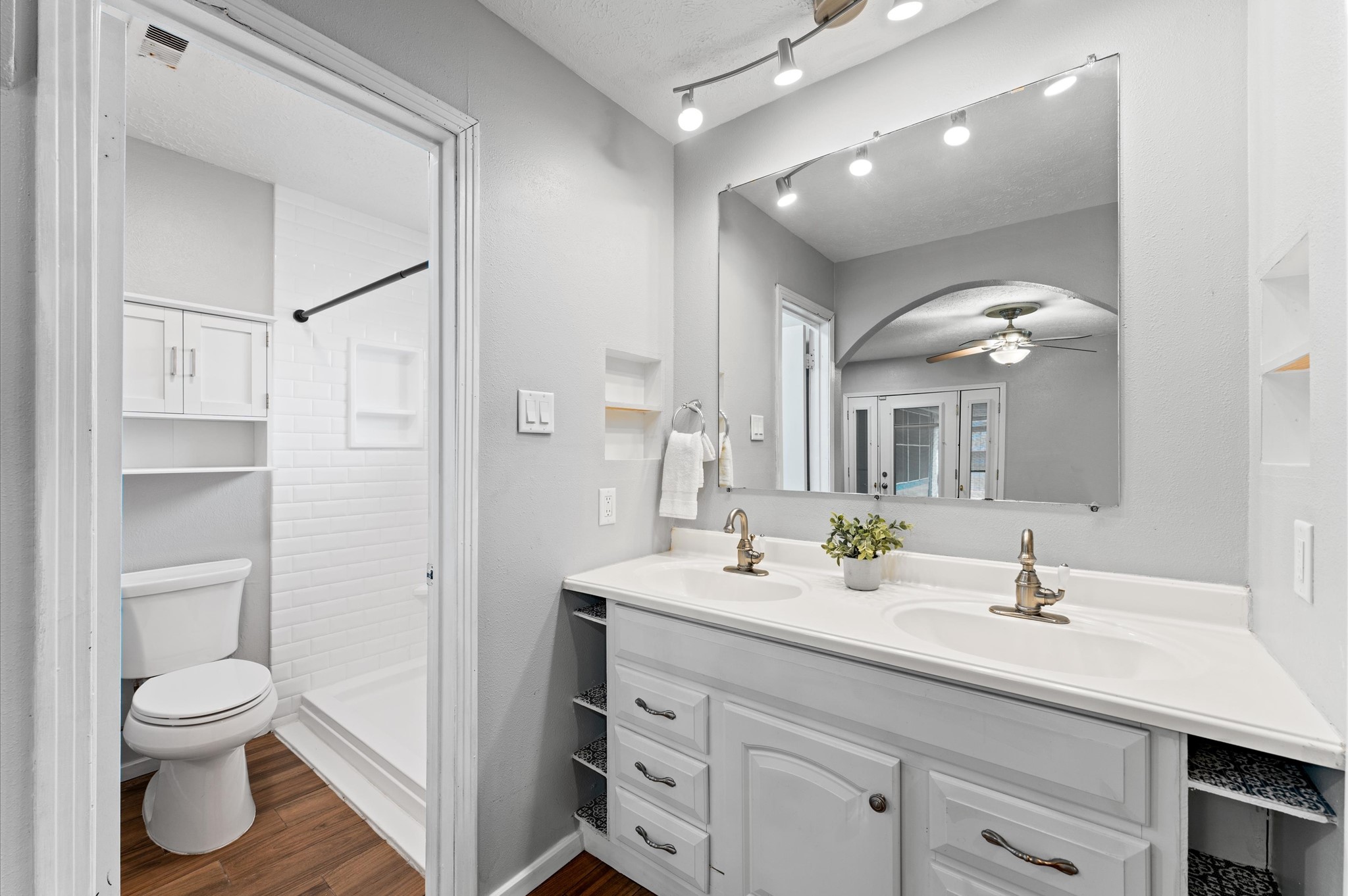 To the left of the dual sink vanity is the primary bath.