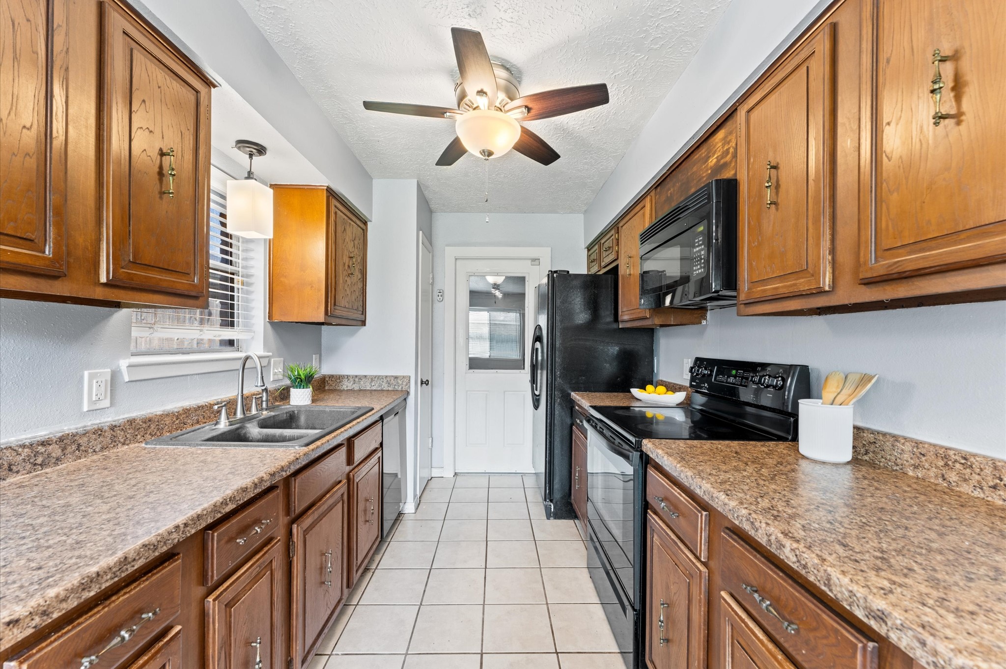 A traditional galley kitchen design keeps everything you need within reach, and the fridge is included!