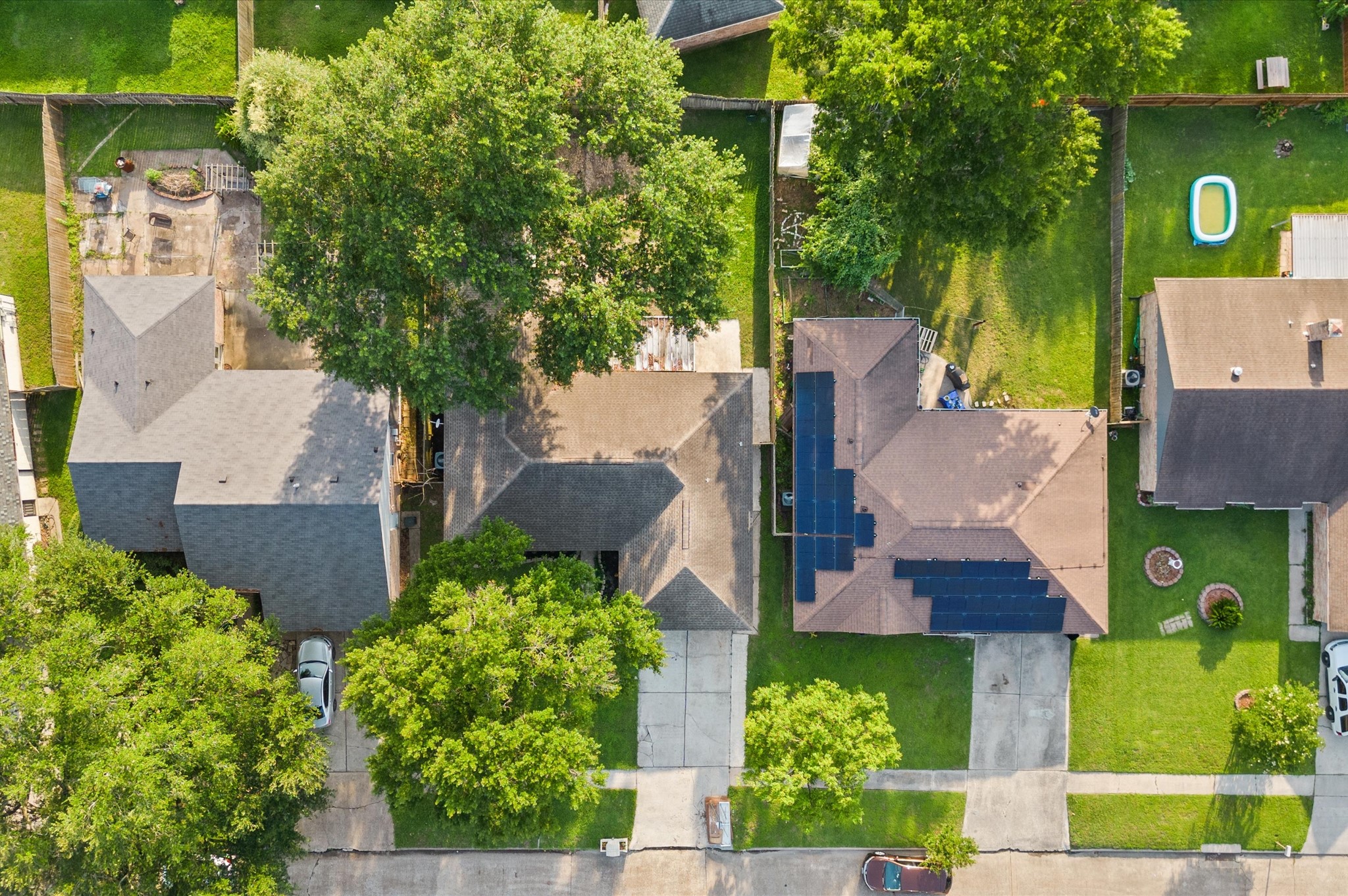 An overhead view accents the many trees located in and around the neighborhood.