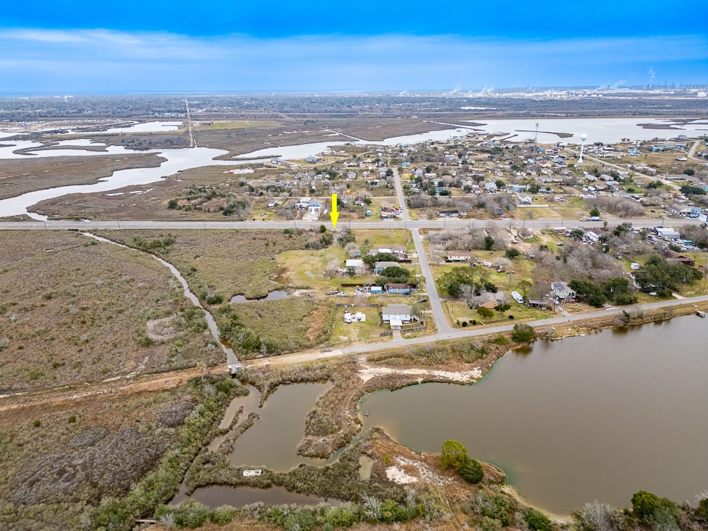 Aerial view from across the nearby waterway with arrow identifying the subject property's Highway 6 location. Aerial view from across the nearby waterway with arrow identifying the subject property's Highway 6 location.