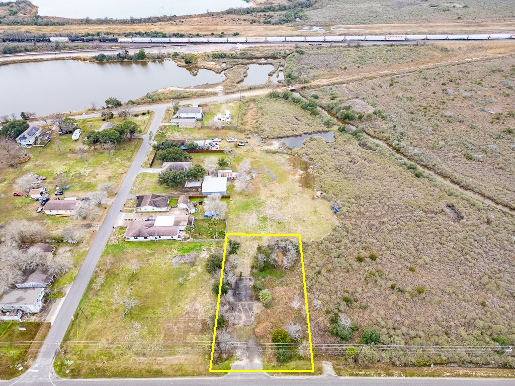 Elevated aerial view highlighting the subject property, Highway 6 frontage, surrounding development, nearby waterways, and rail corridor. Elevated aerial view highlighting the subject property, Highway 6 frontage, surrounding development, nearby waterways, and rail corridor.