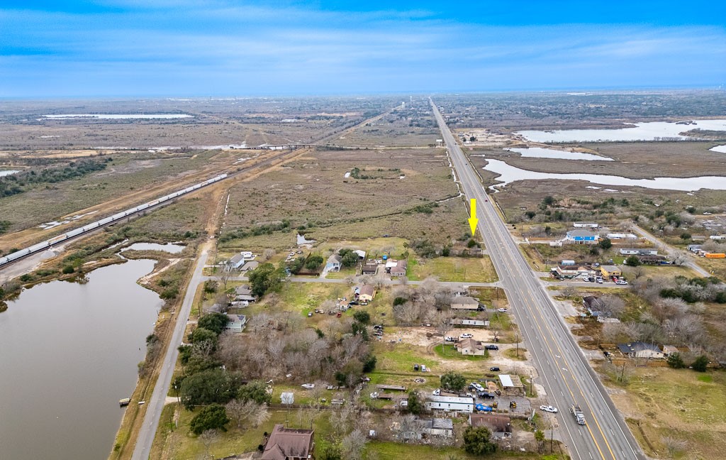 Long-range aerial view with arrow identifying the property and highlighting visibility along the Highway 6 corridor. Long-range aerial view with arrow identifying the property and highlighting visibility along the Highway 6 corridor.