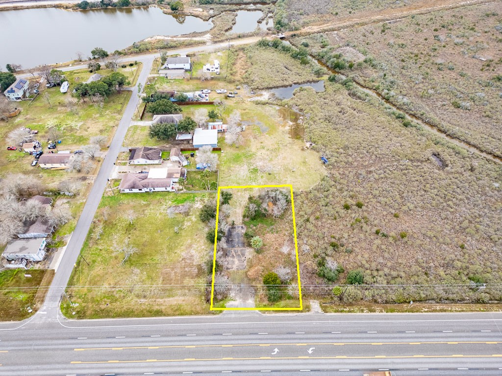 Aerial view highlighting the approximate boundaries of the 15,000 sq. ft. commercial property with approximately 100 feet of frontage along Highway 6 Aerial view highlighting the approximate boundaries of the 15,000 sq. ft. commercial property with approximately 100 feet of frontage along Highway 6