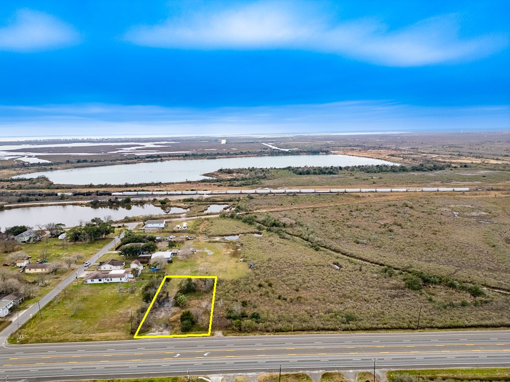 Aerial view highlighting the approximate property boundaries and approximately 100 feet of Highway 6 frontage. Aerial view highlighting the approximate property boundaries and approximately 100 feet of Highway 6 frontage.