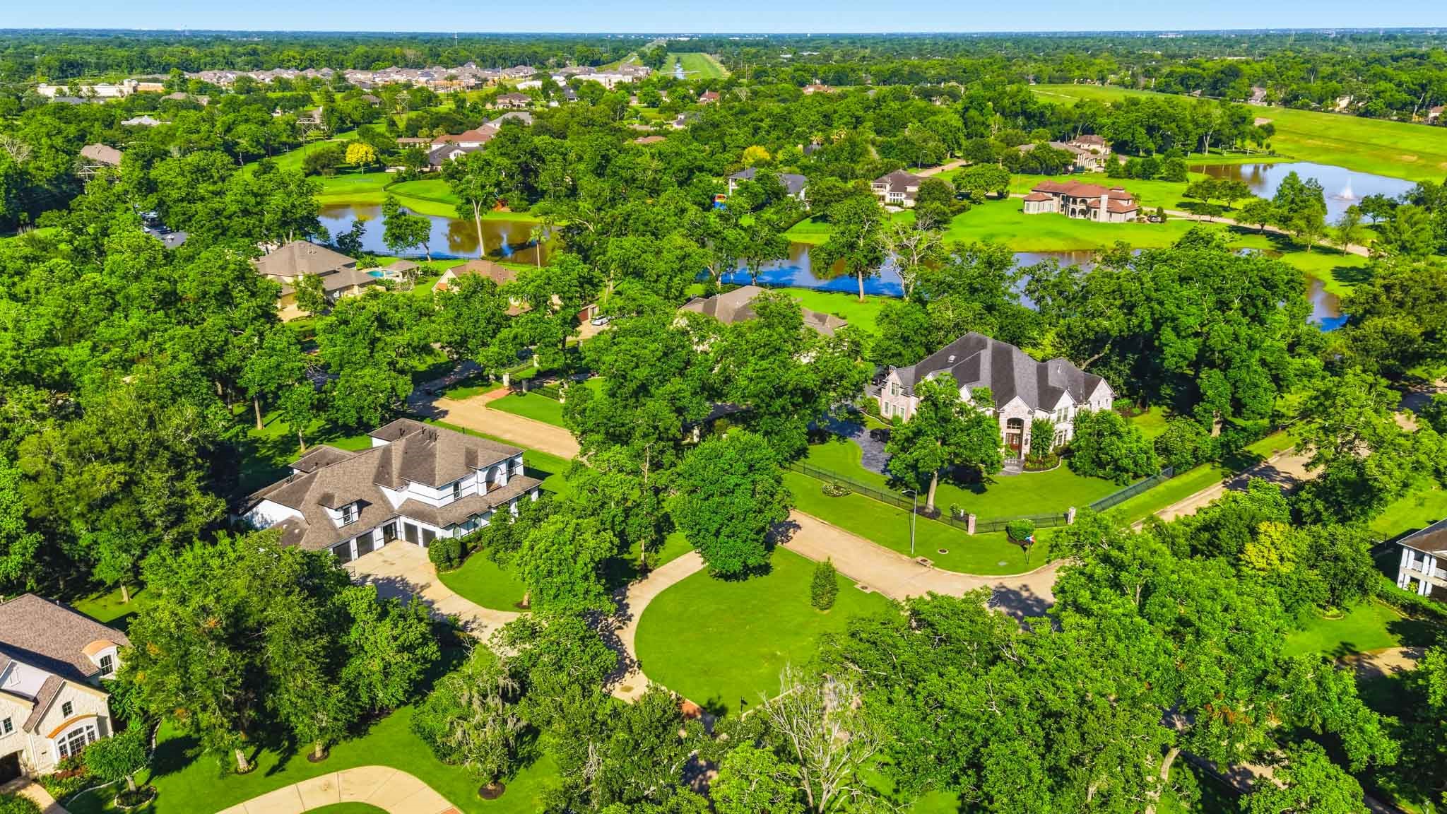 Beautiful birds-eye view highlighting the neighborhood lakes, winding streets, and lush surroundings.