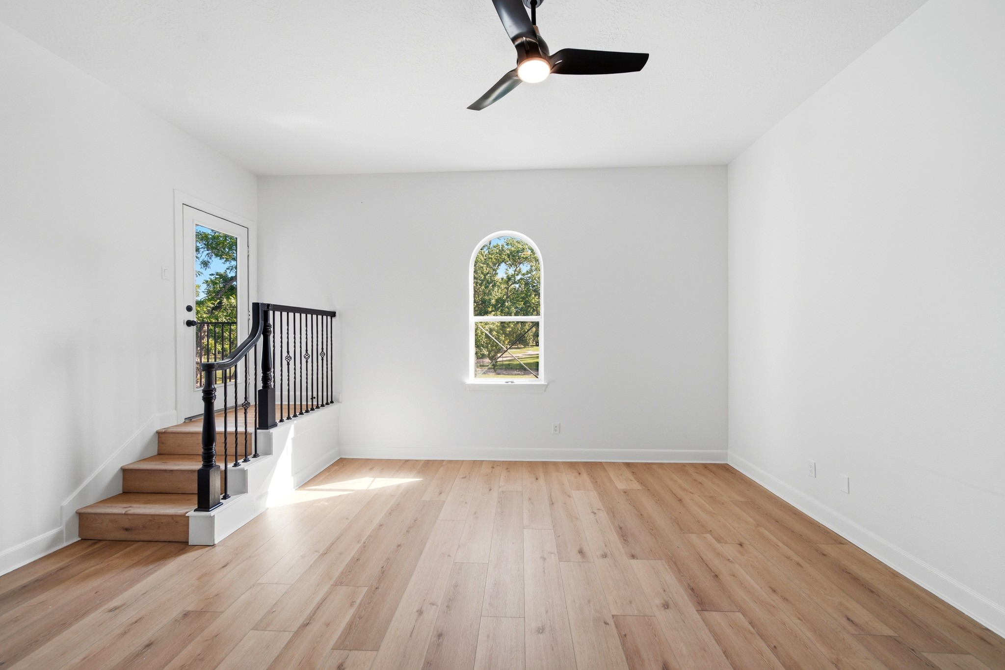 Versatile upstairs retreat with private balcony access and abundant natural light.