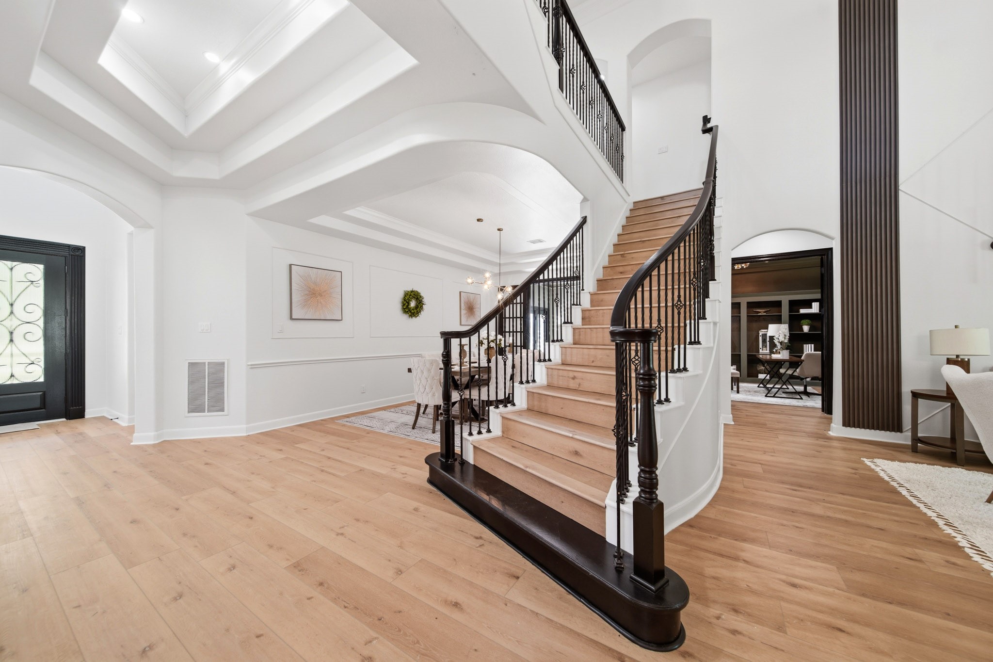Grand entry with soaring ceilings, elegant staircase, and designer finishes throughout.
