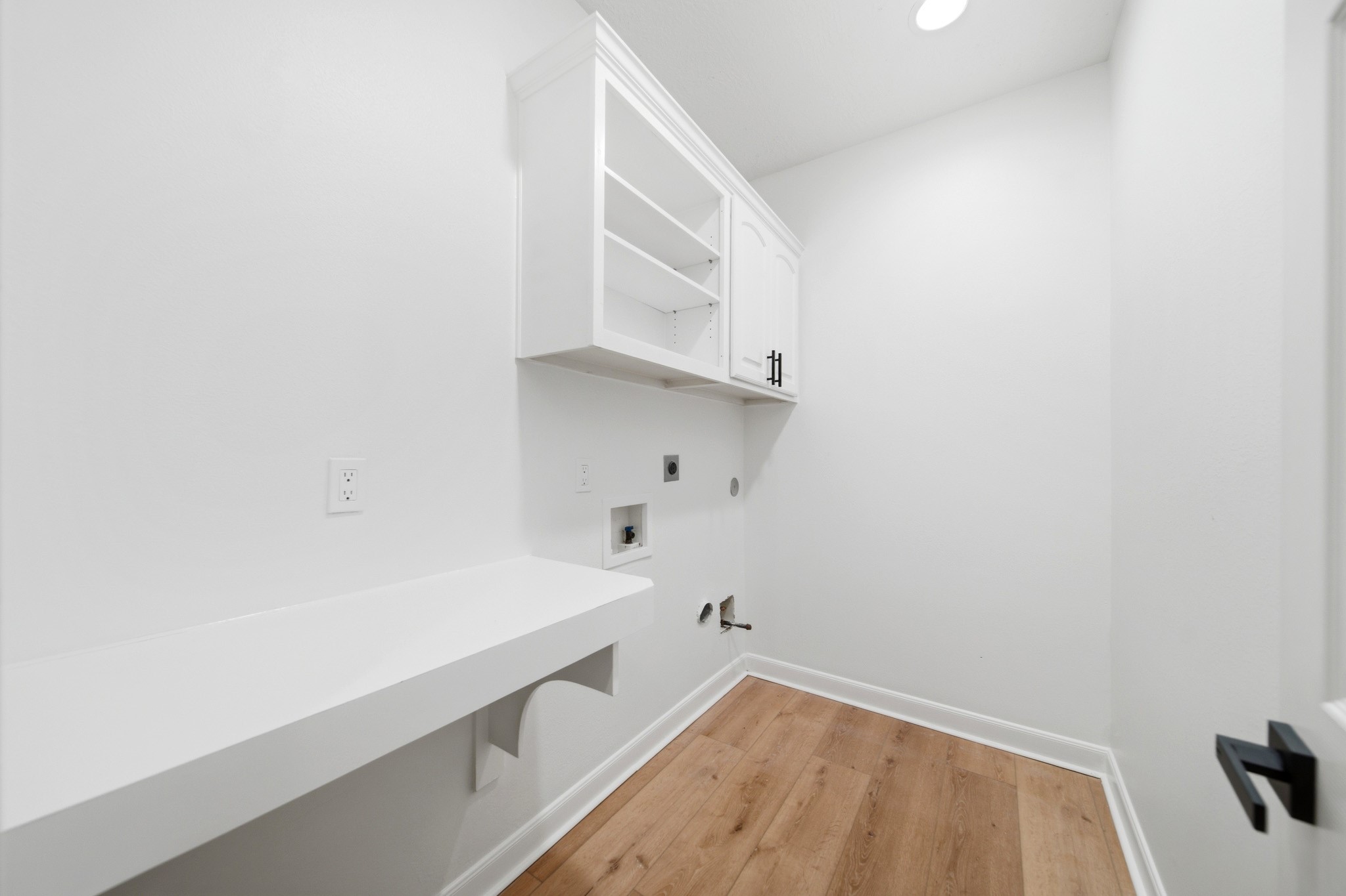 Laundry room with ample storage space.
