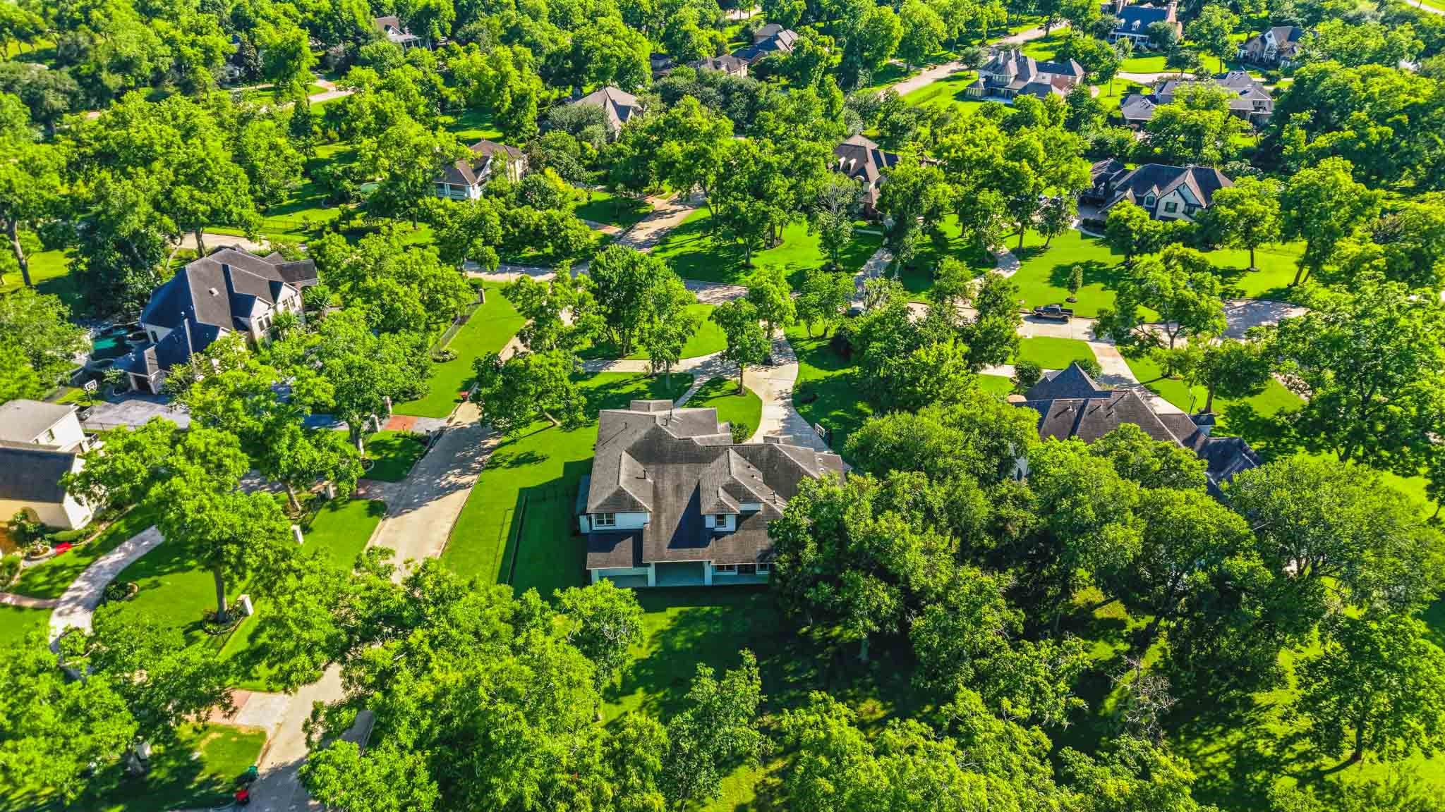 Stunning aerial view showcasing the estate-sized homesites and mature trees throughout the community.