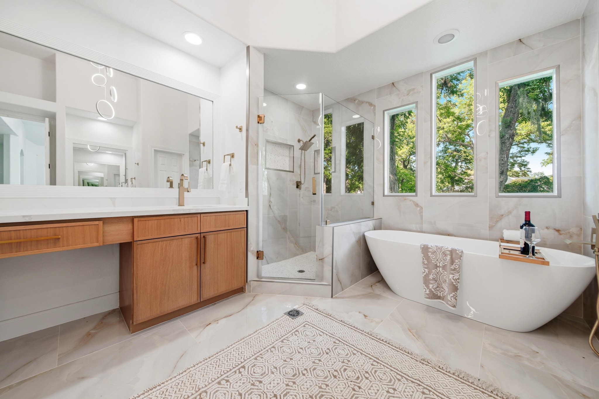 Resort-style bathroom showcasing elegant finishes, natural light, and modern luxury.
