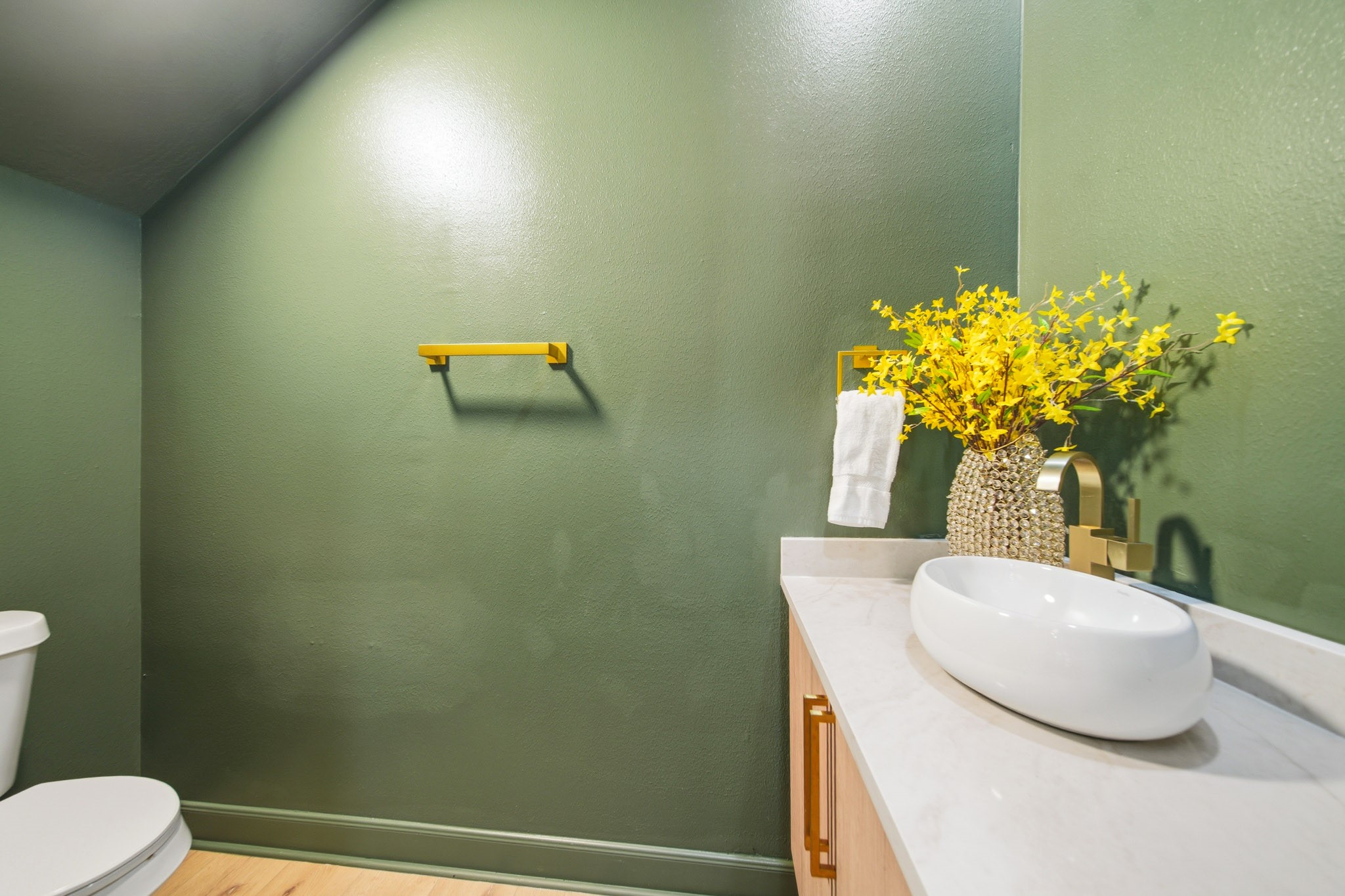 Stylish powder bath with designer vessel sink and bold accent wall.