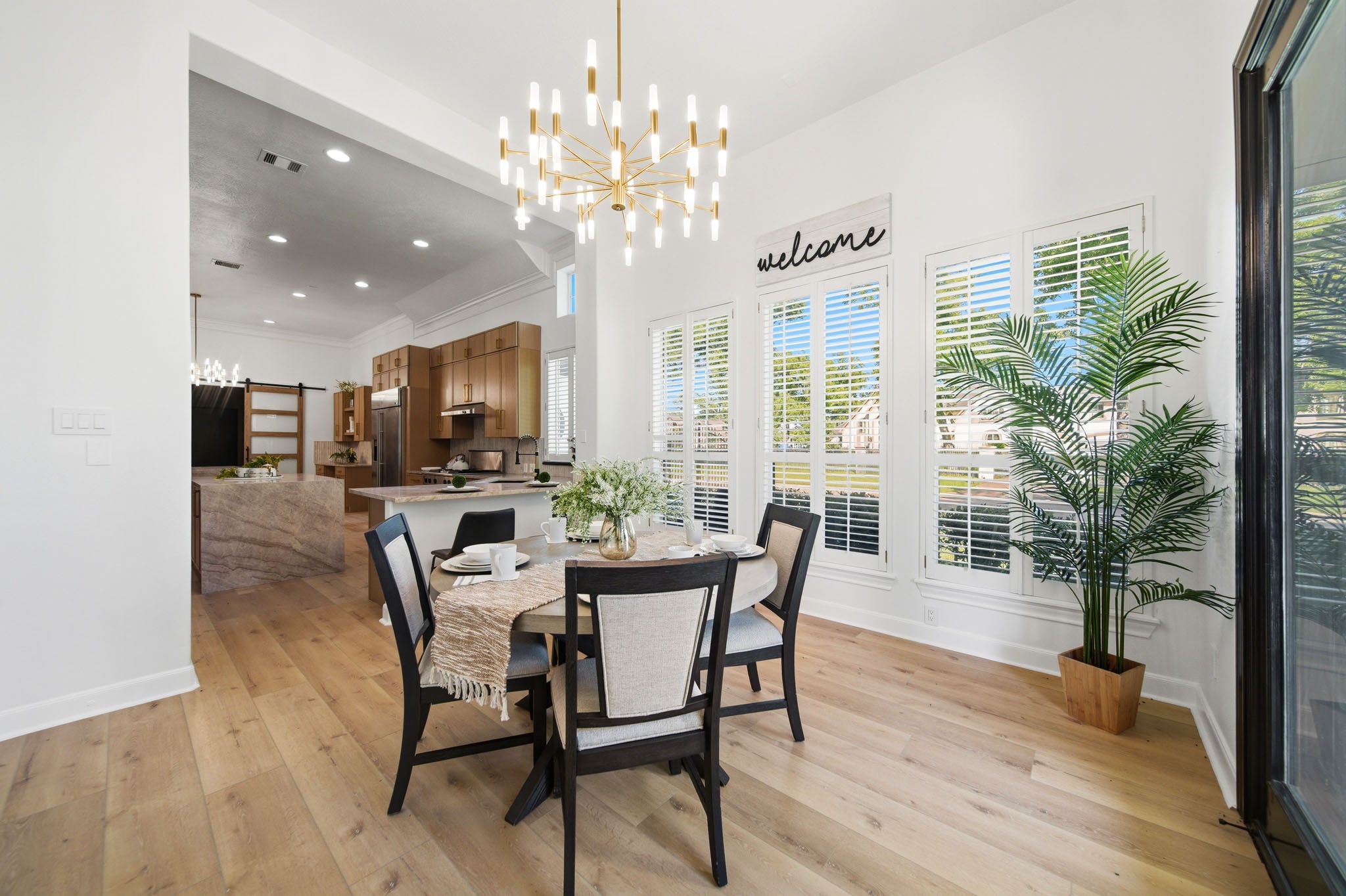 Bright breakfast area with modern lighting and plantation shutters.
