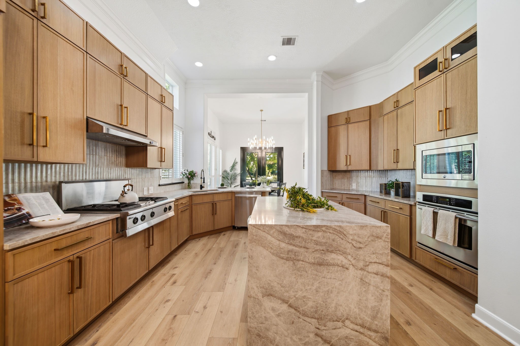 Chef-inspired kitchen with custom cabinetry, premium finishes, and oversized waterfall island.